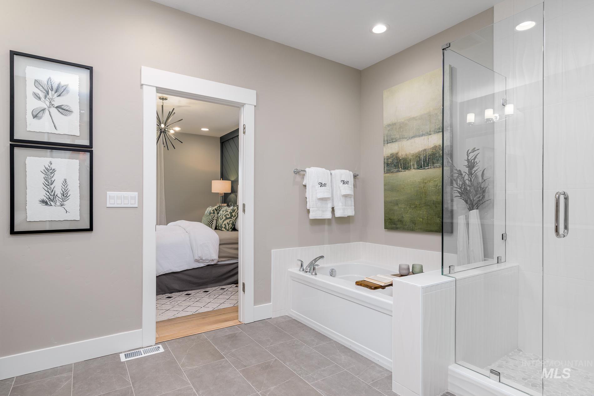 Full bathroom with a stall shower, a garden tub, recessed lighting, light tile patterned floors, and ensuite bathroom