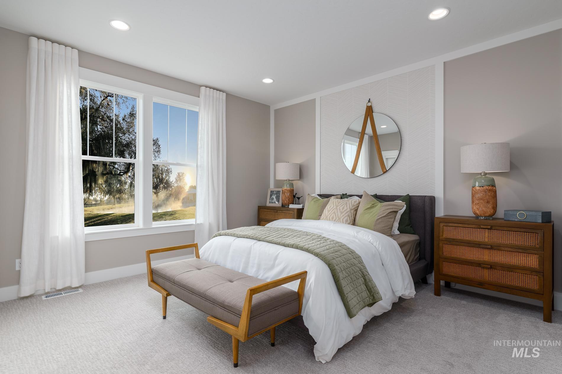 Carpeted bedroom with multiple windows and recessed lighting
