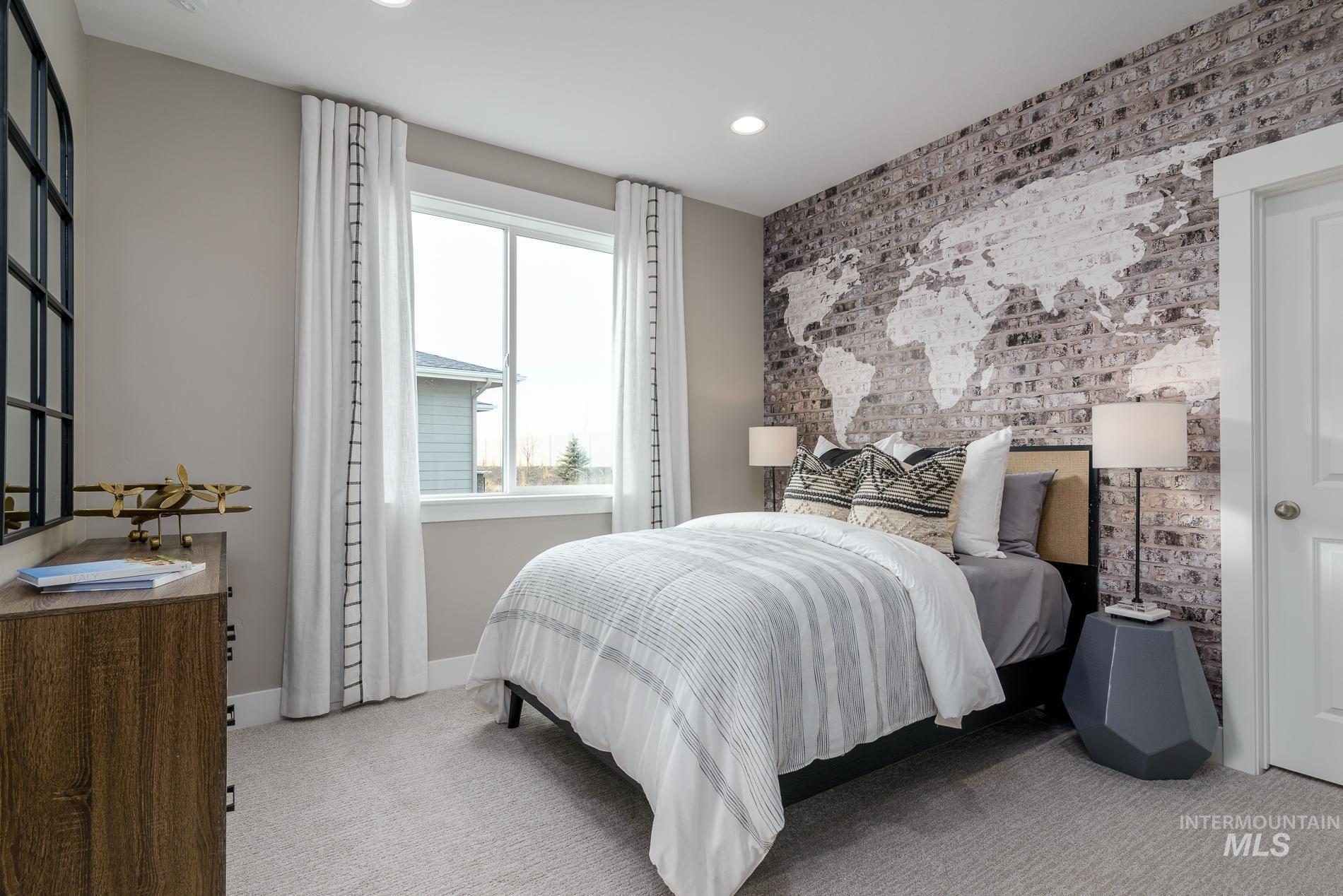 Bedroom with brick wall, carpet, an accent wall, and recessed lighting