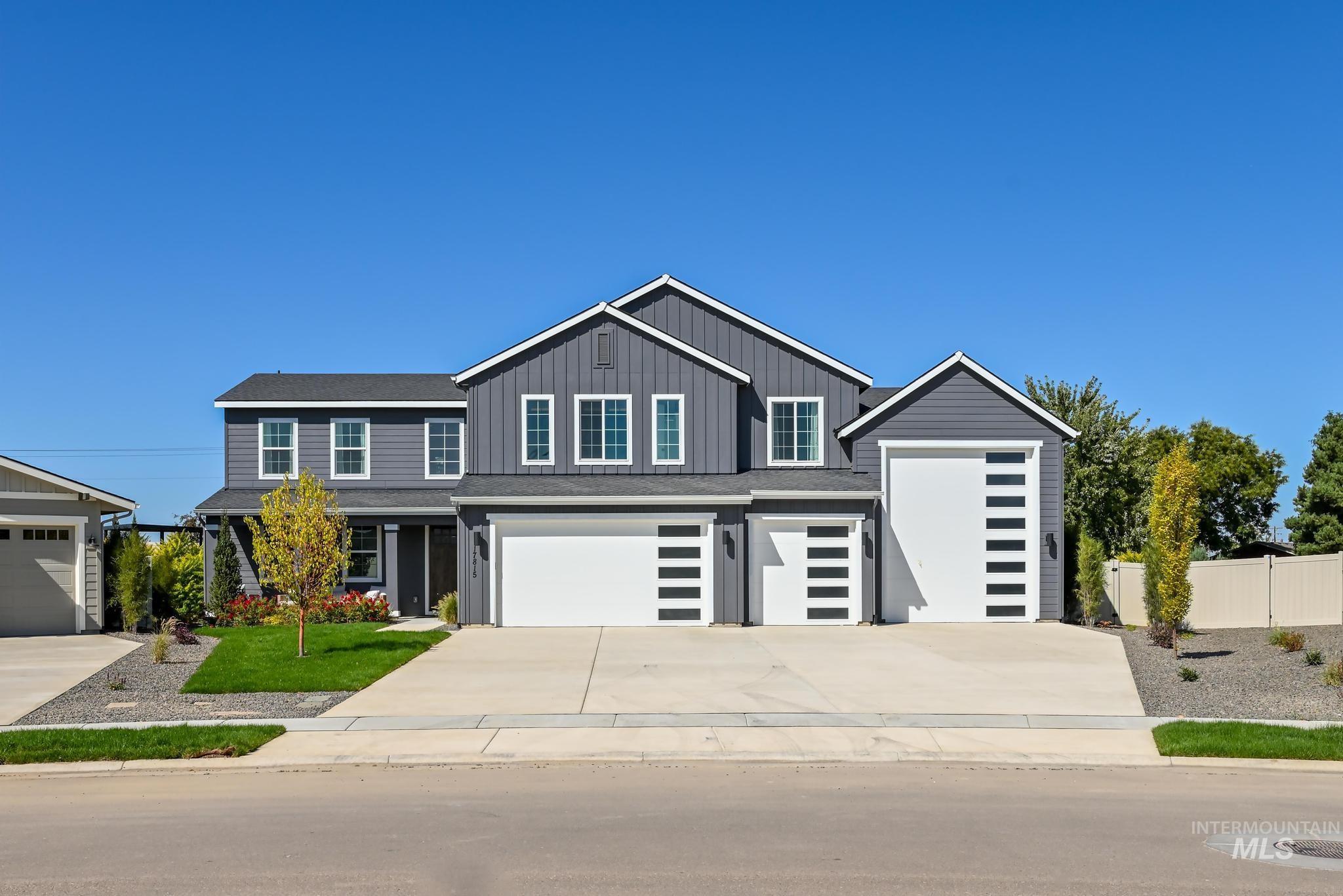 View of front facade featuring concrete driveway and board and batten siding