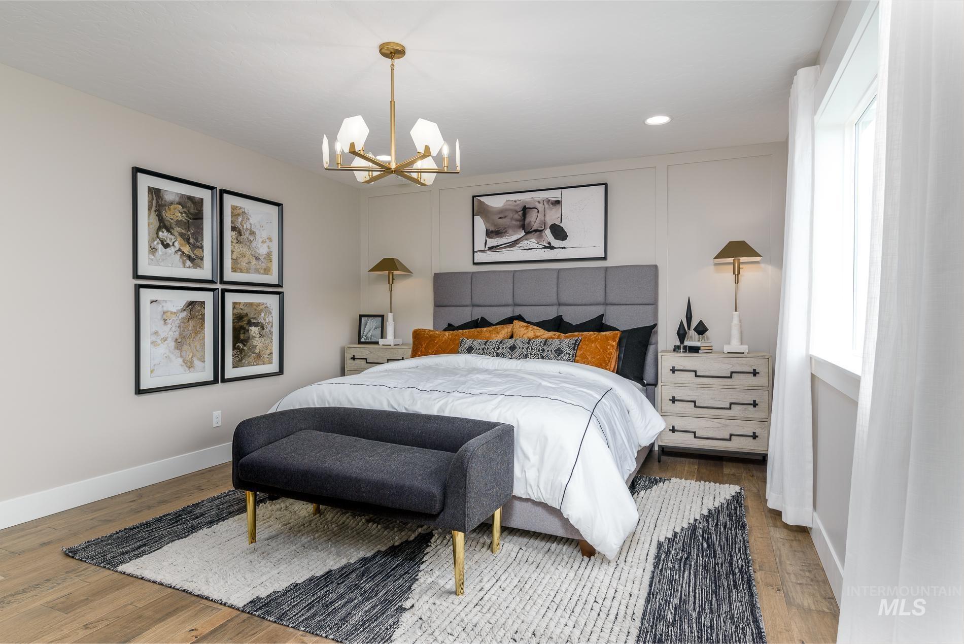 Bedroom with recessed lighting, wood finished floors, a chandelier, and a decorative wall