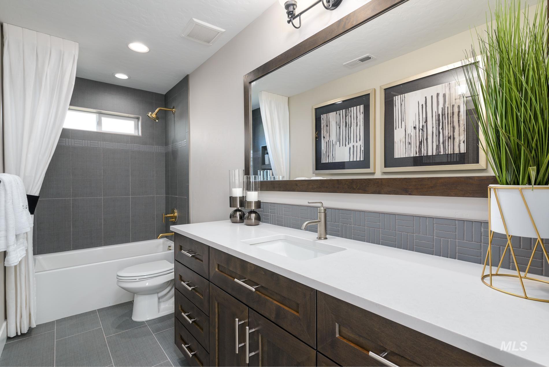 Full bath featuring shower / bathtub combination with curtain, vanity, dark tile patterned floors, and recessed lighting
