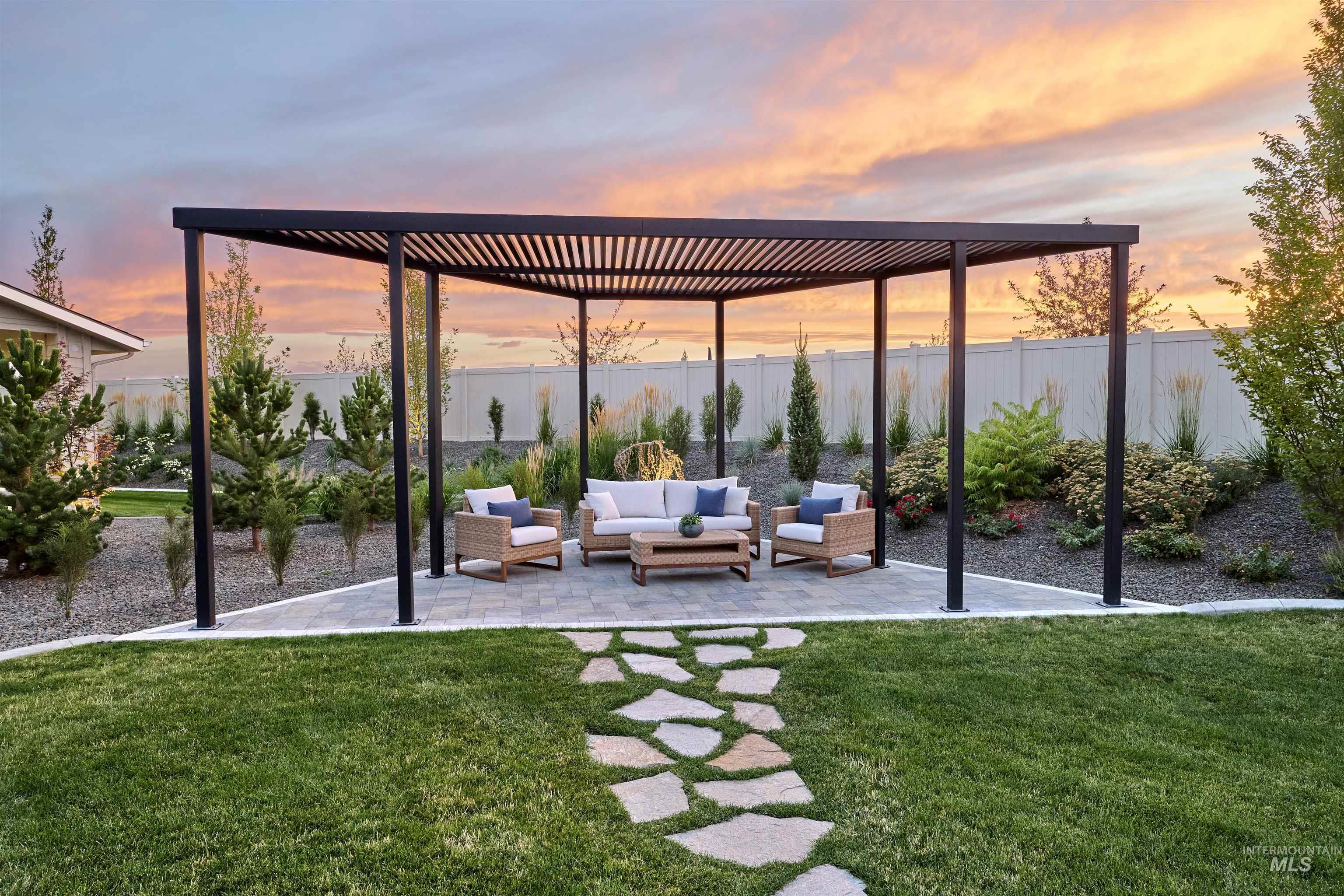 Patio terrace at dusk featuring outdoor lounge area, a patio area, a fenced backyard, and a pergola