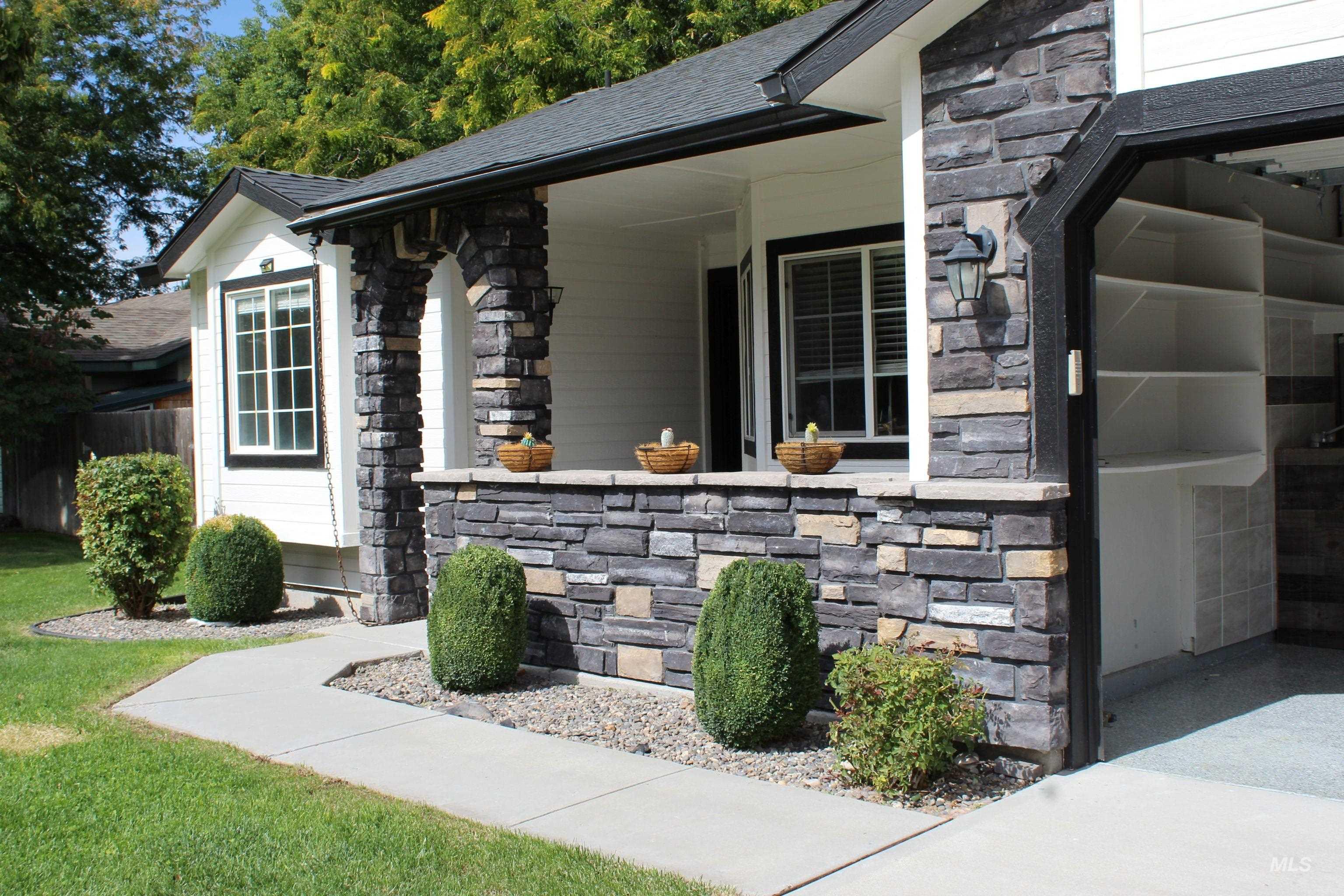 View of exterior entry with stone siding
