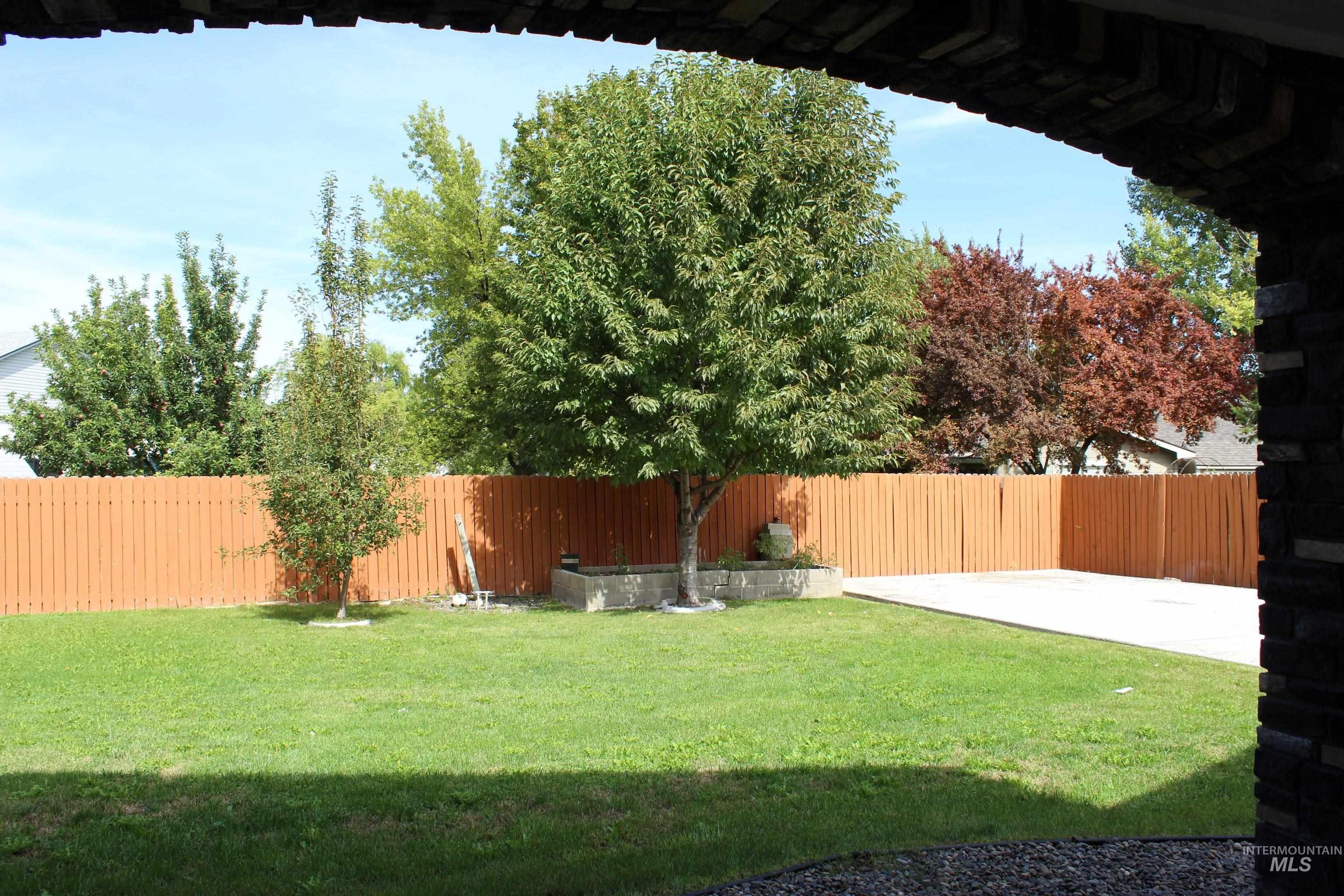 Fenced backyard with a patio area