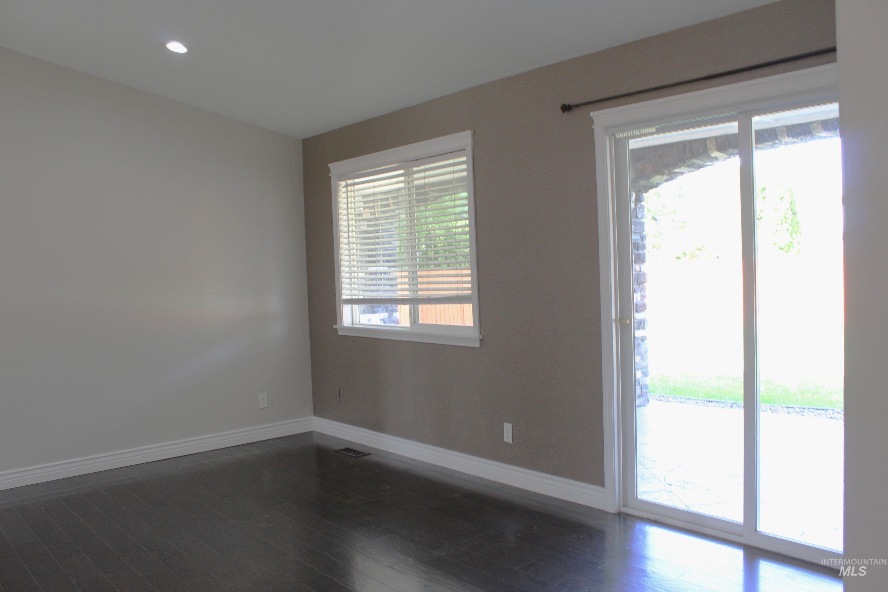 Spare room with dark wood finished floors and recessed lighting