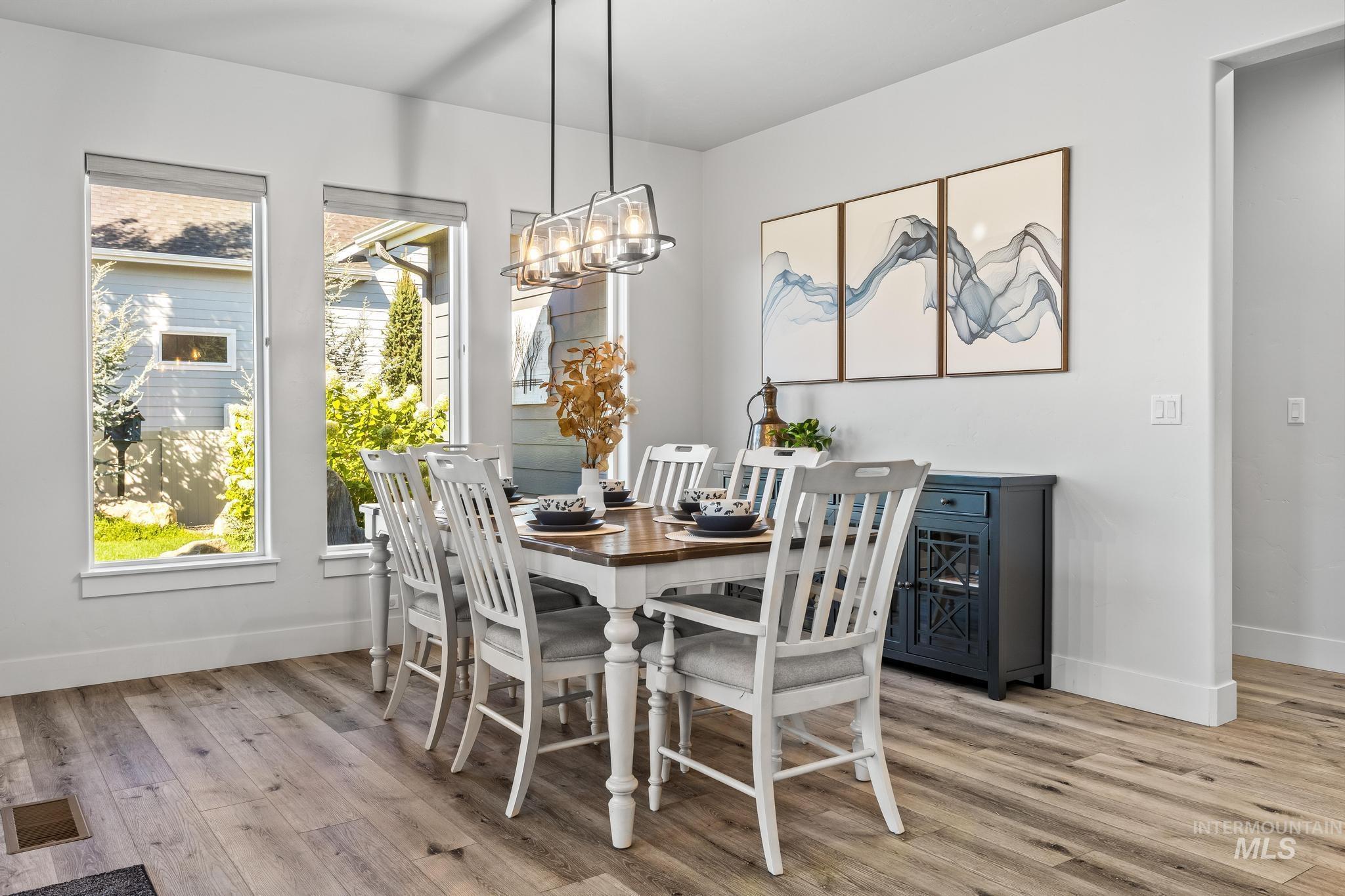 Dining space featuring light wood-style flooring and a chandelier