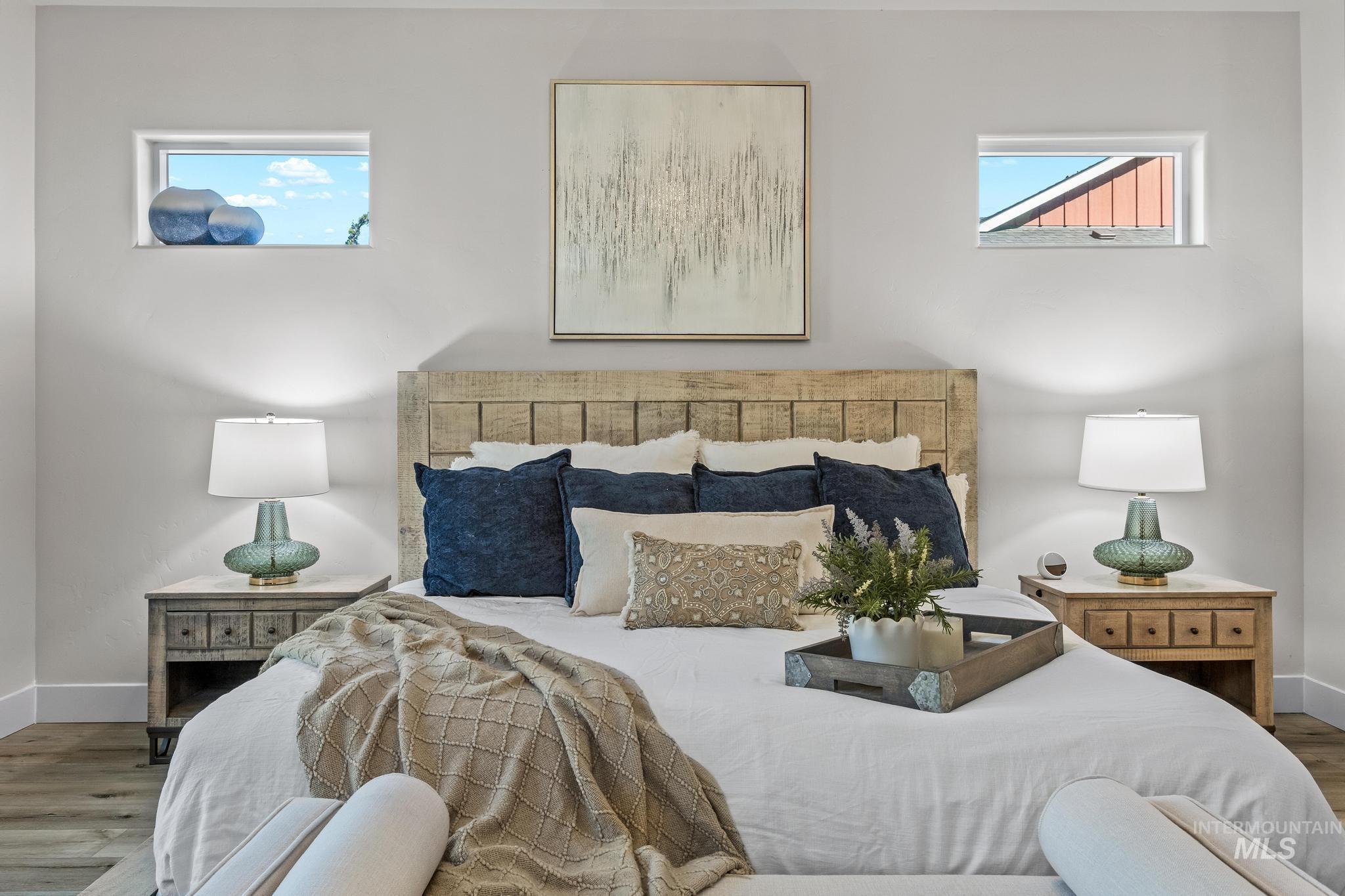 Bedroom with wood finished floors and baseboards