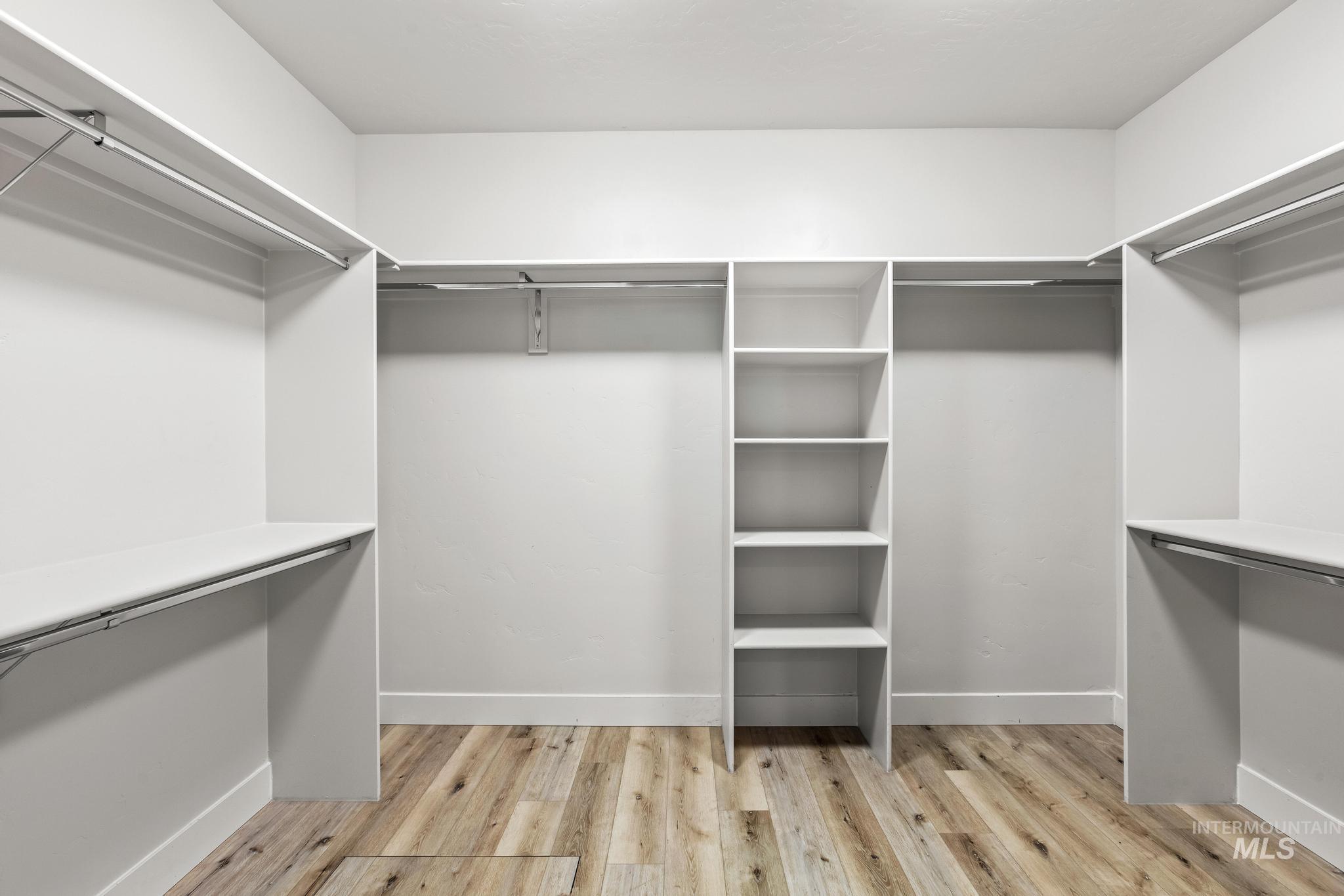 Walk in closet featuring light wood finished floors