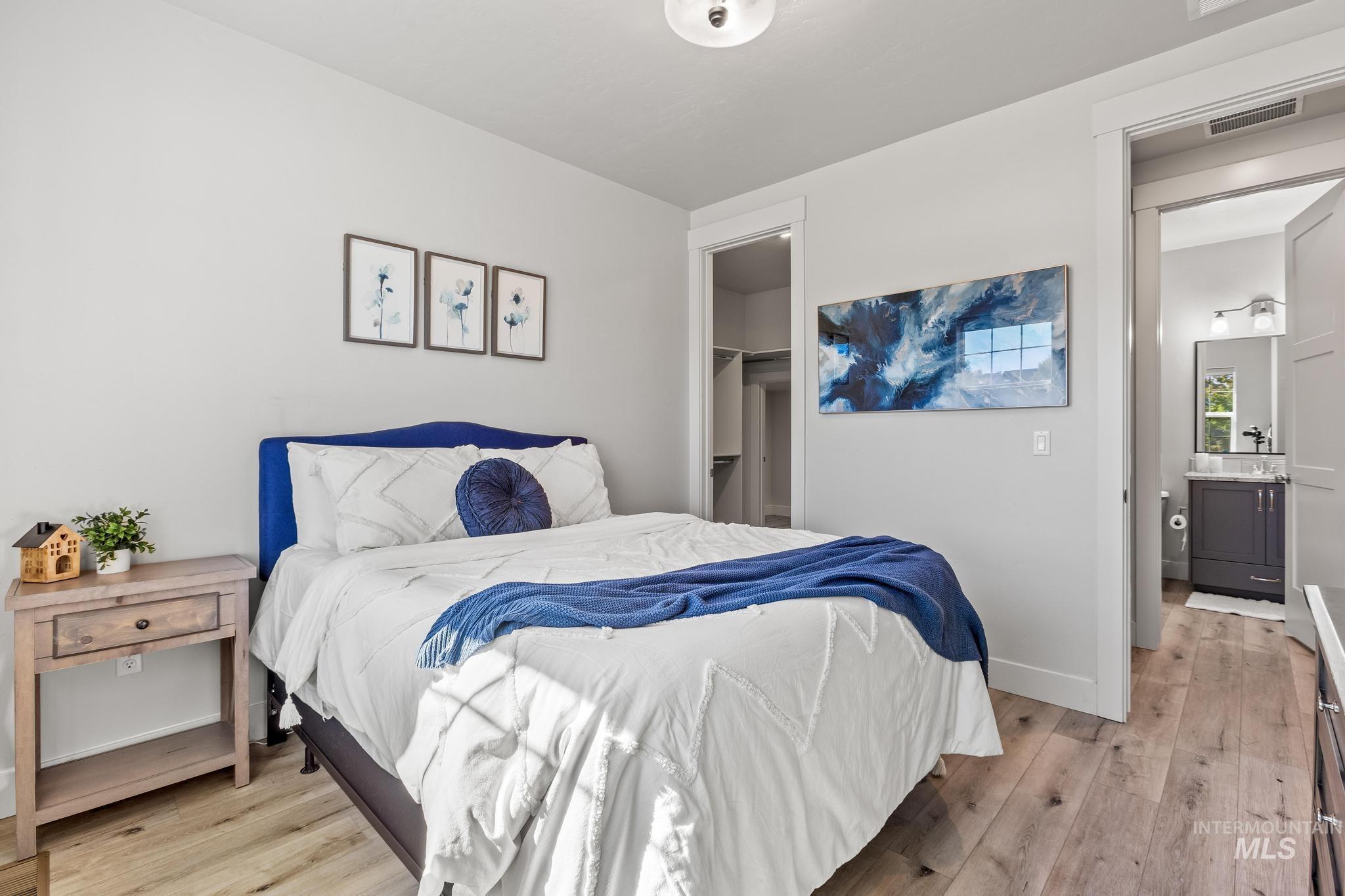Bedroom featuring light wood-style floors and a walk in closet