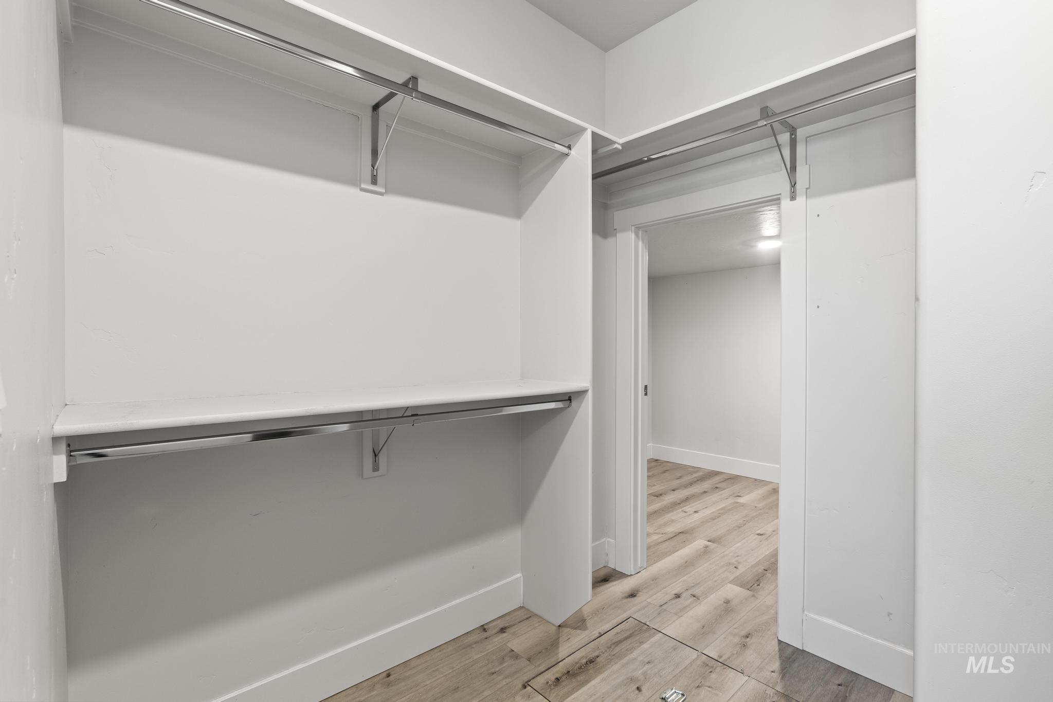 Spacious closet with light wood-style floors