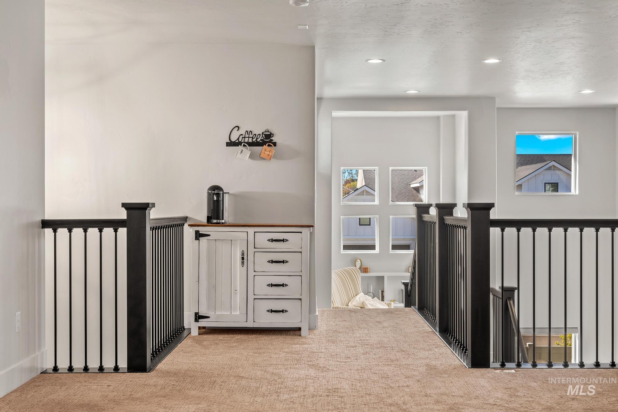 Corridor featuring carpet flooring, an upstairs landing, recessed lighting, and radiator heating unit