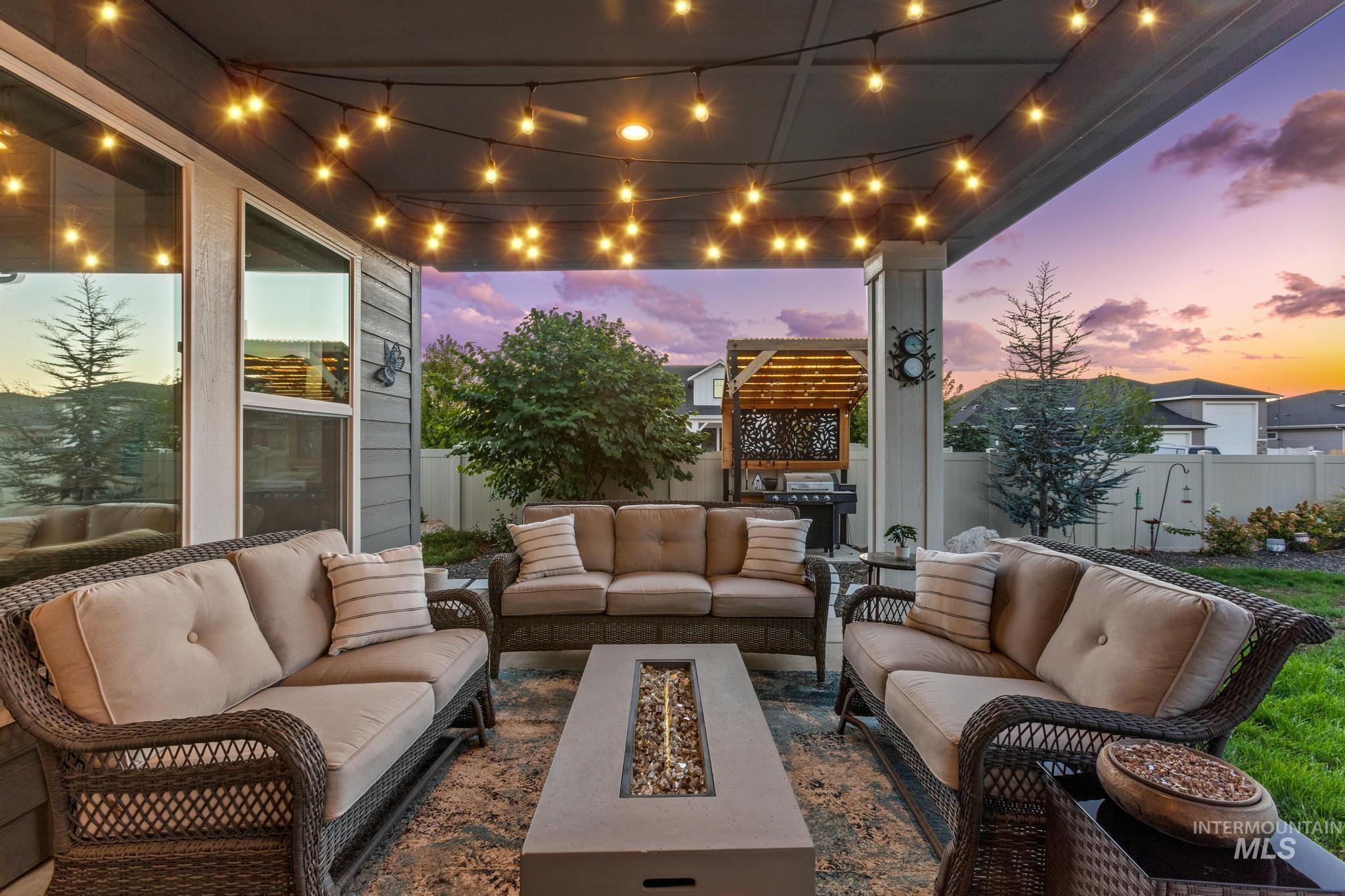 View of patio / terrace featuring an outdoor living space with a fire pit and grilling area