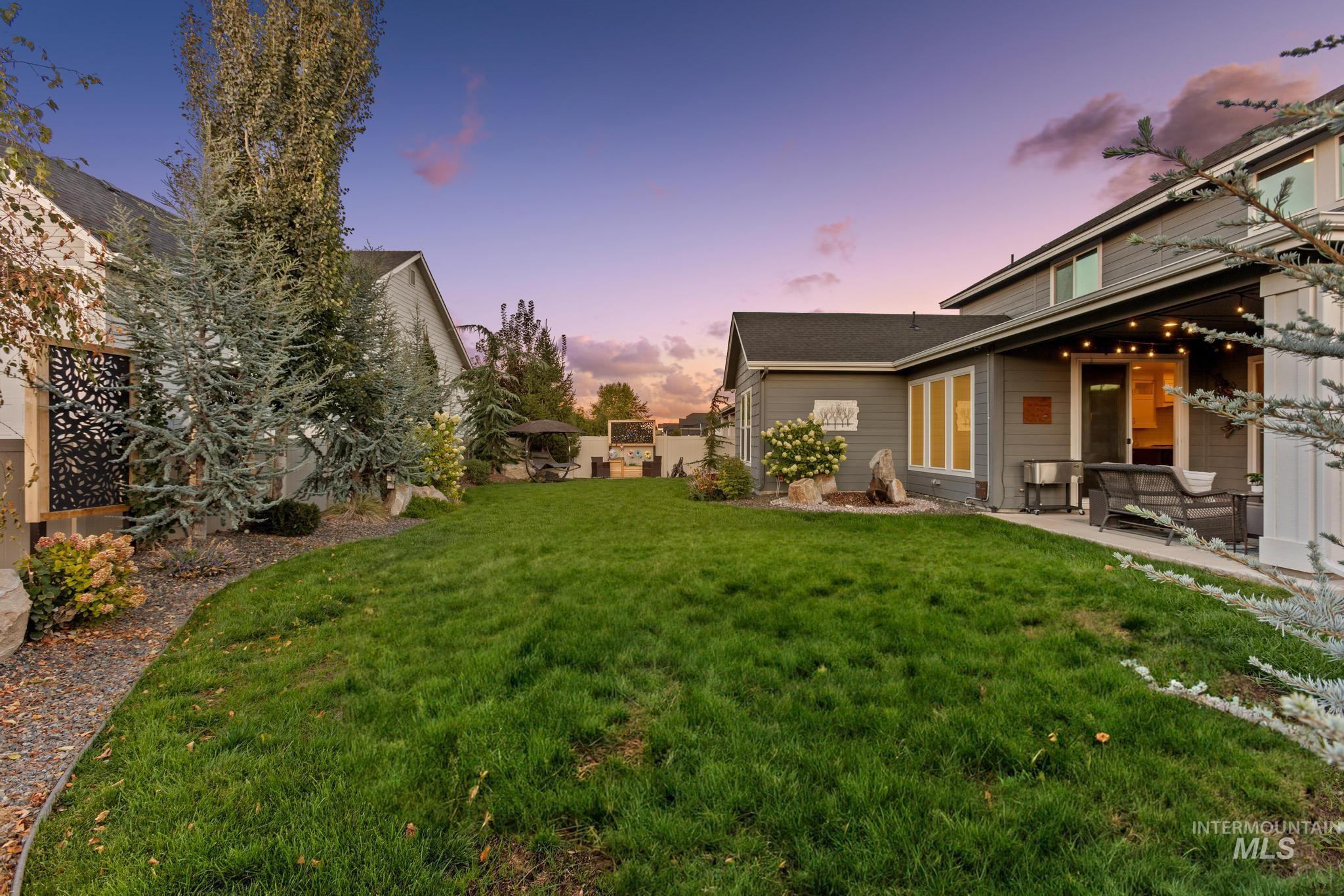 Yard at dusk featuring a patio area