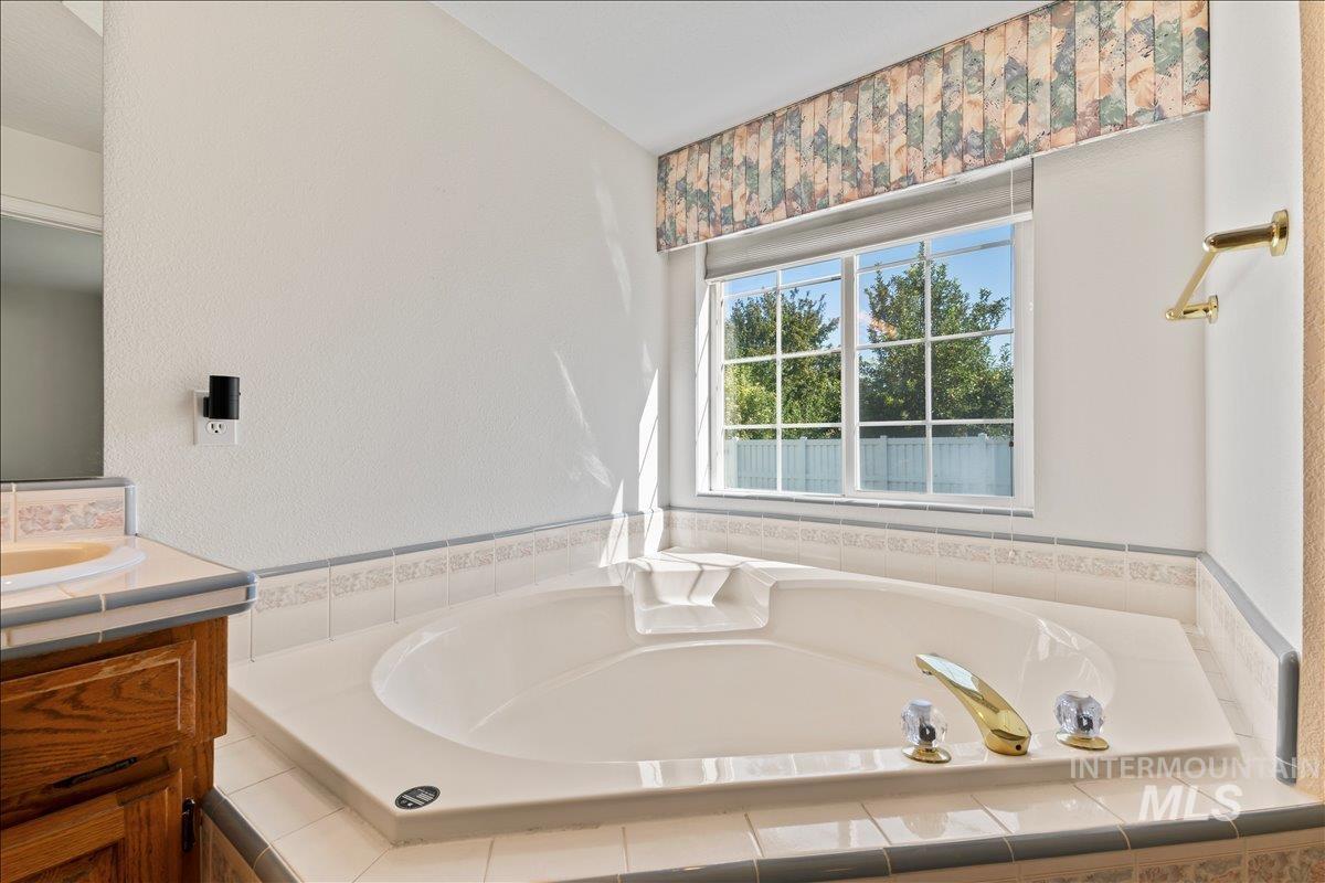 Bathroom with vanity and a bath