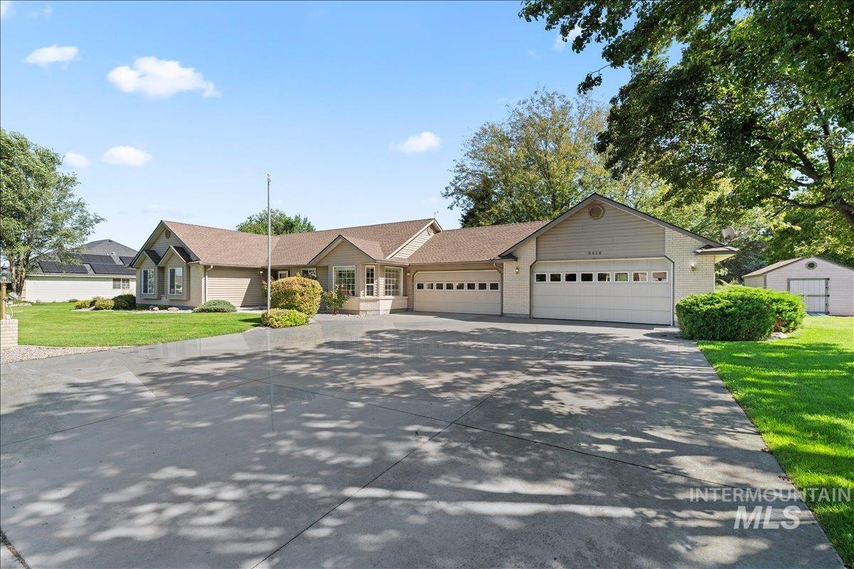 Single story home featuring a front lawn, concrete driveway, and a garage