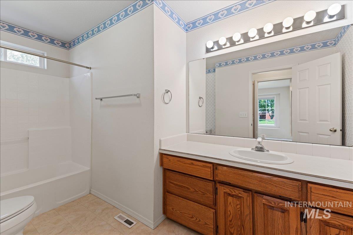 Bathroom with vanity,  shower combination, and light tile patterned floors