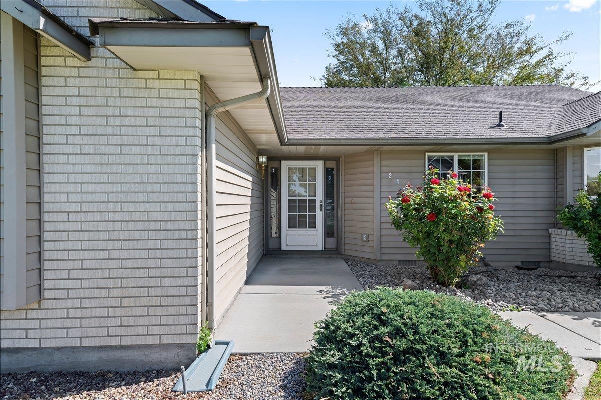 Property entrance with a shingled roof
