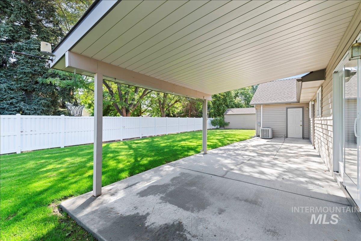Fenced backyard with a patio