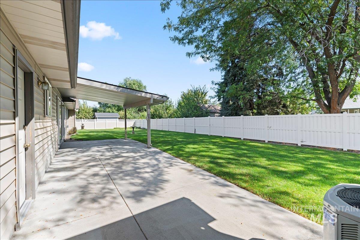 Fenced backyard with a patio
