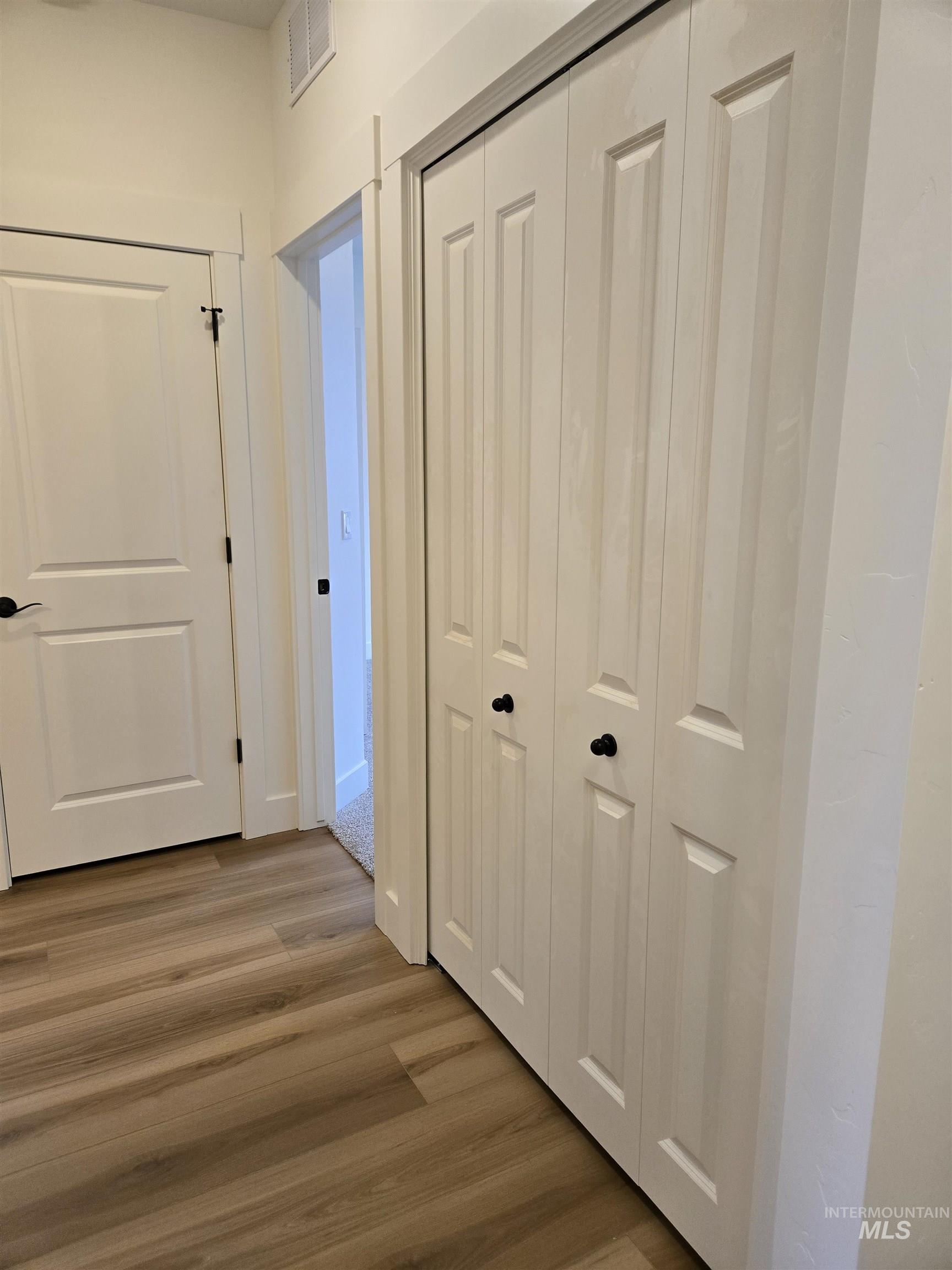 Hall featuring wood finished floors