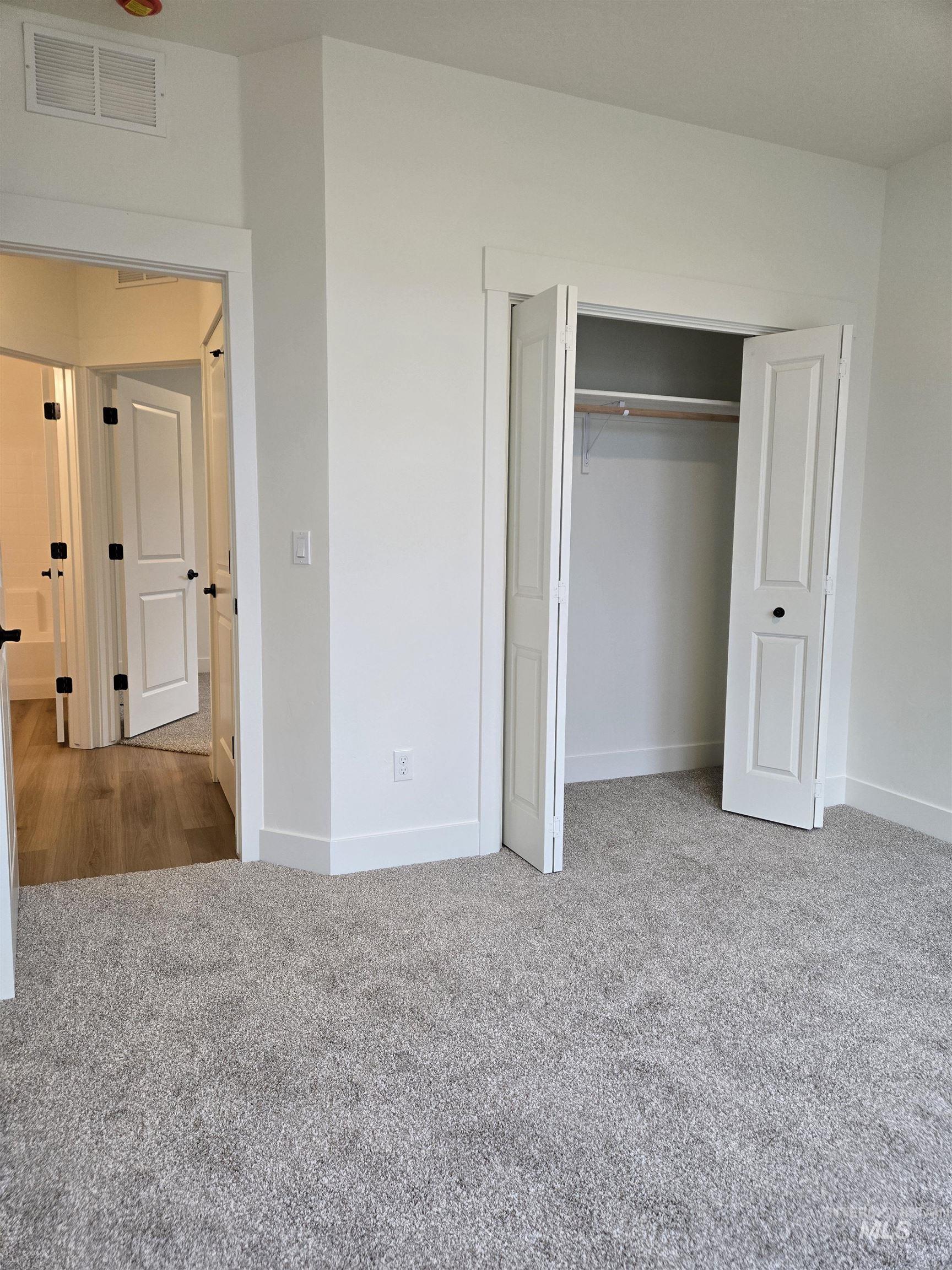 Unfurnished bedroom featuring light colored carpet and a closet