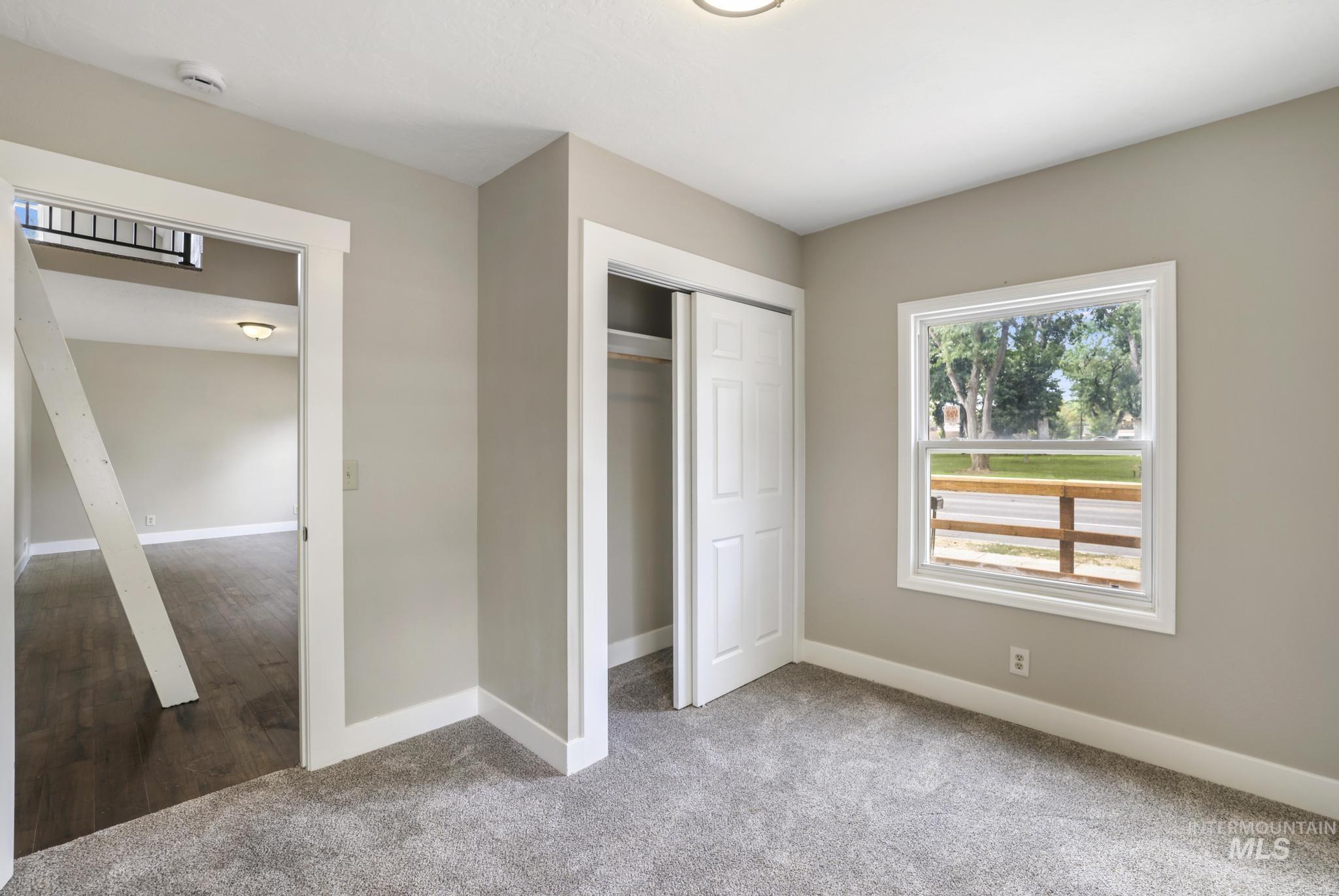 Unfurnished bedroom featuring a closet and carpet