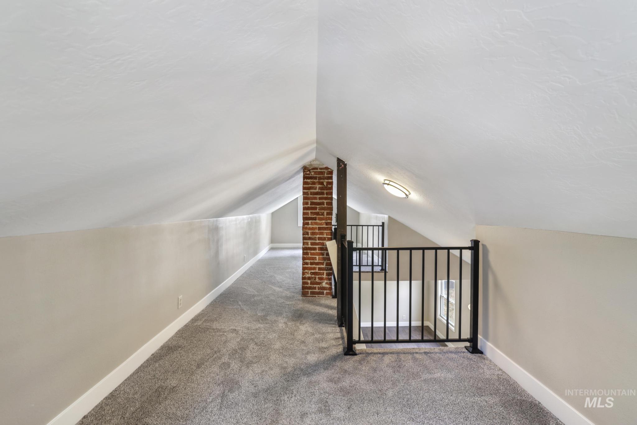 Bonus room featuring carpet flooring and lofted ceiling