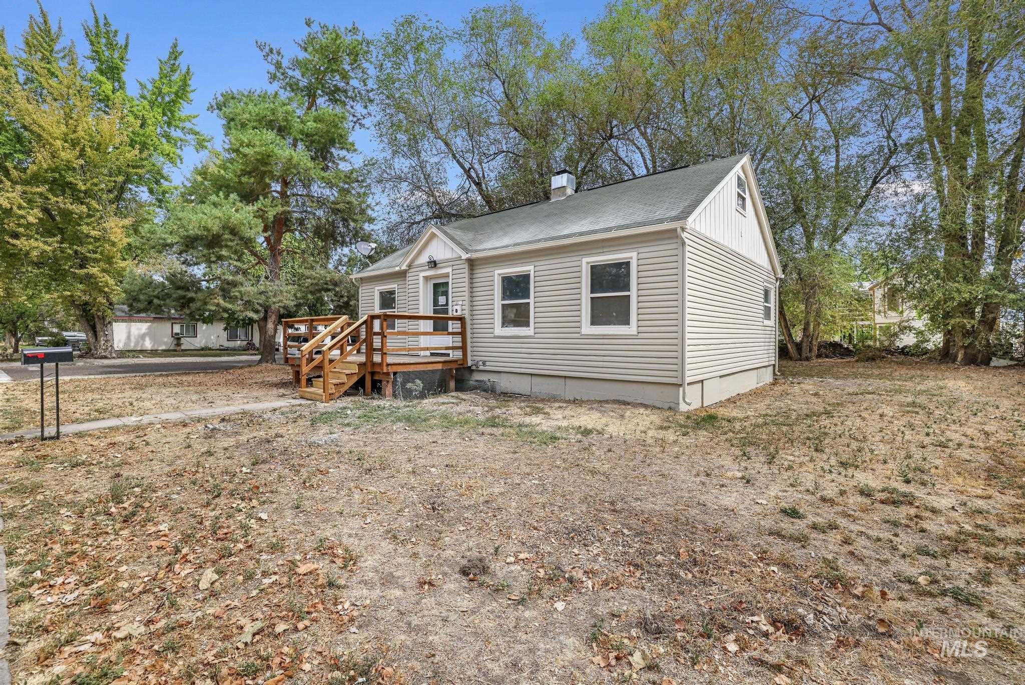 Bungalow-style house with a wooden deck, crawl space, a chimney, and a shingled roof