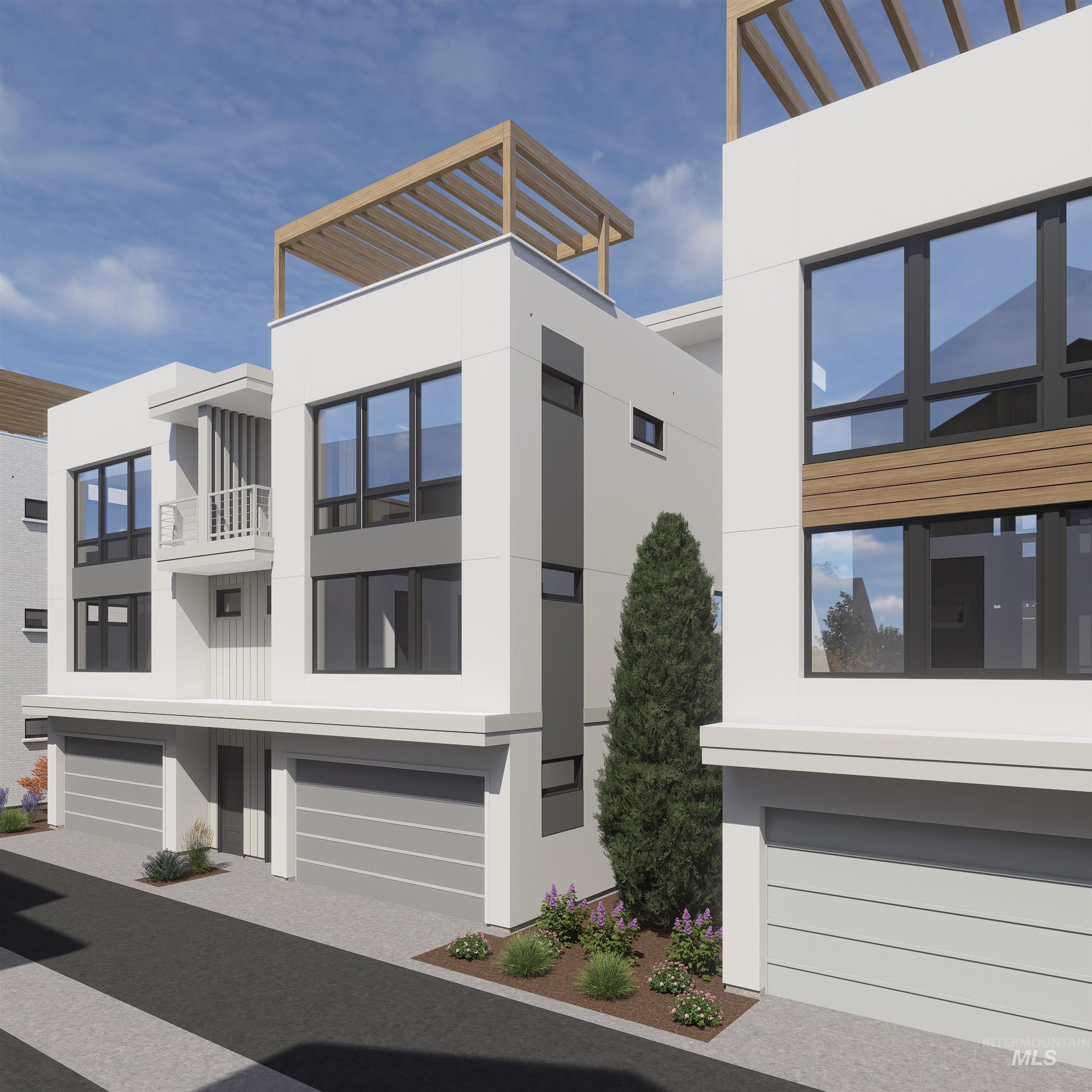 Contemporary house with stucco siding, an attached garage, and driveway
