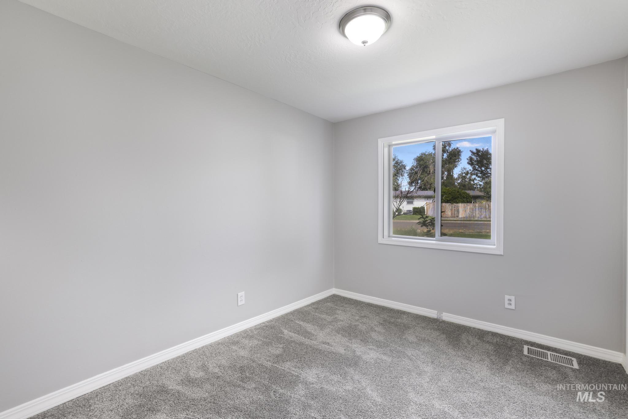Spare room with carpet flooring and baseboards