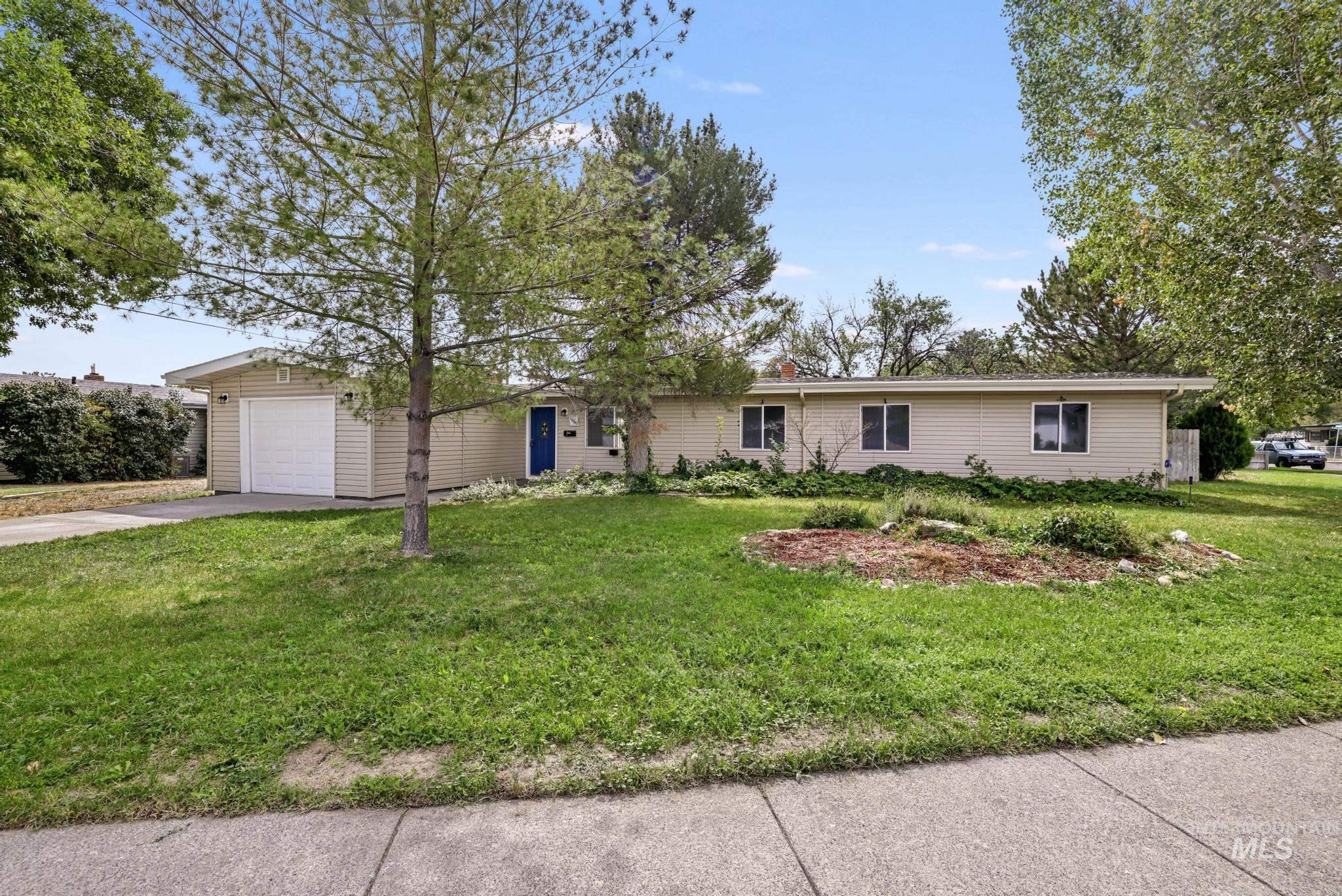 Single story home with concrete driveway, a front lawn, and a chimney