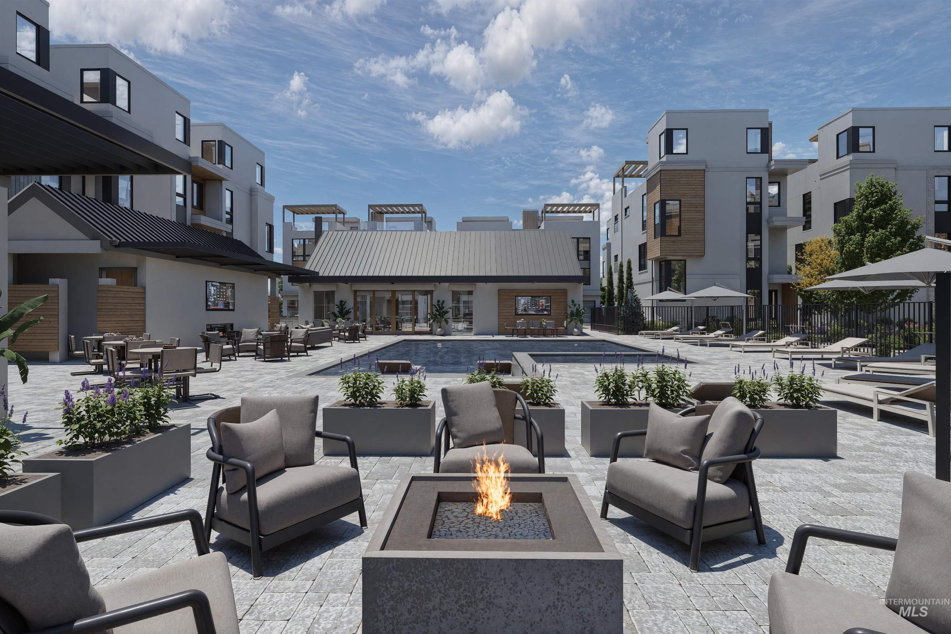 Community pool with a patio area and an outdoor living space with a fire pit