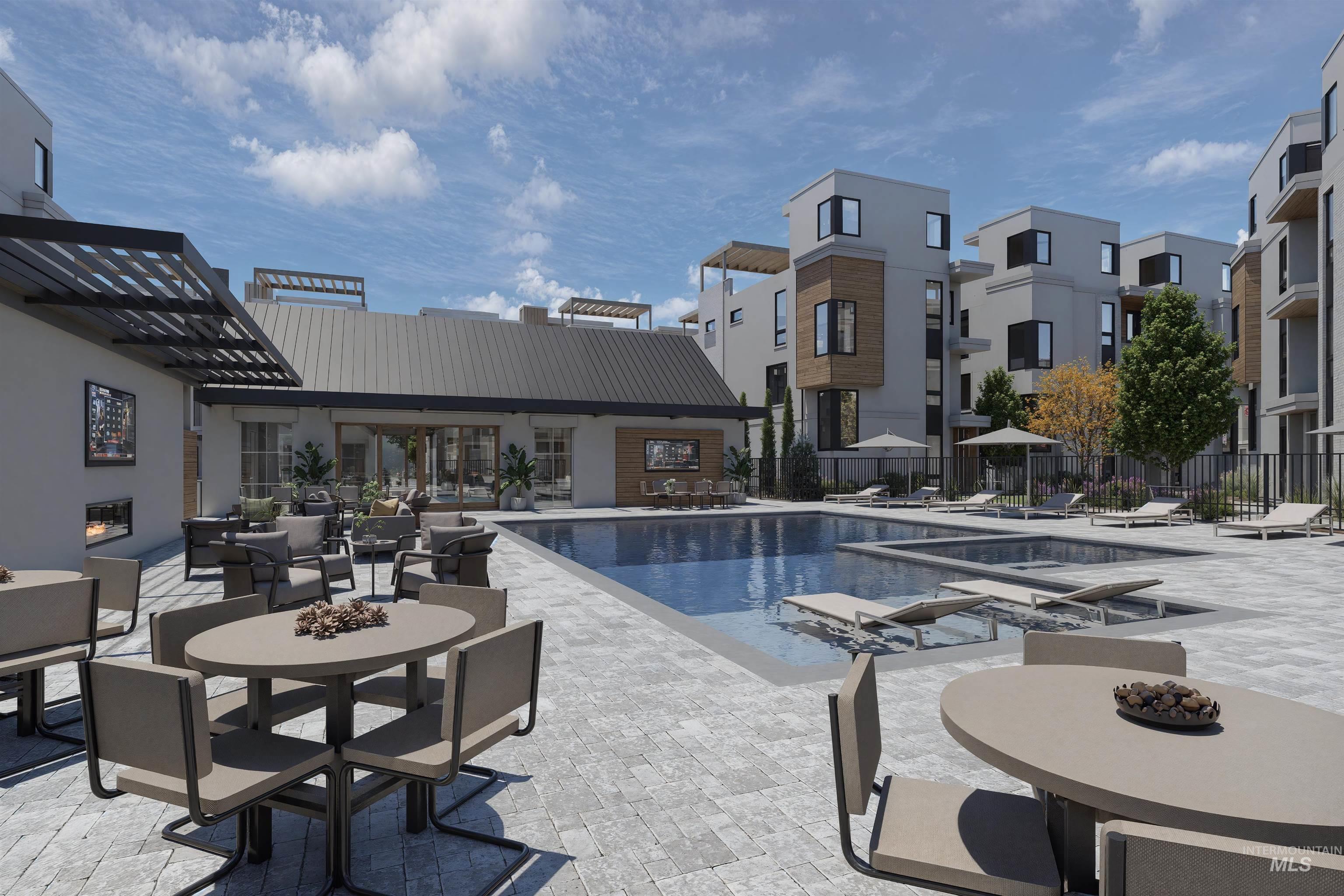 Community pool featuring a patio and outdoor dining area