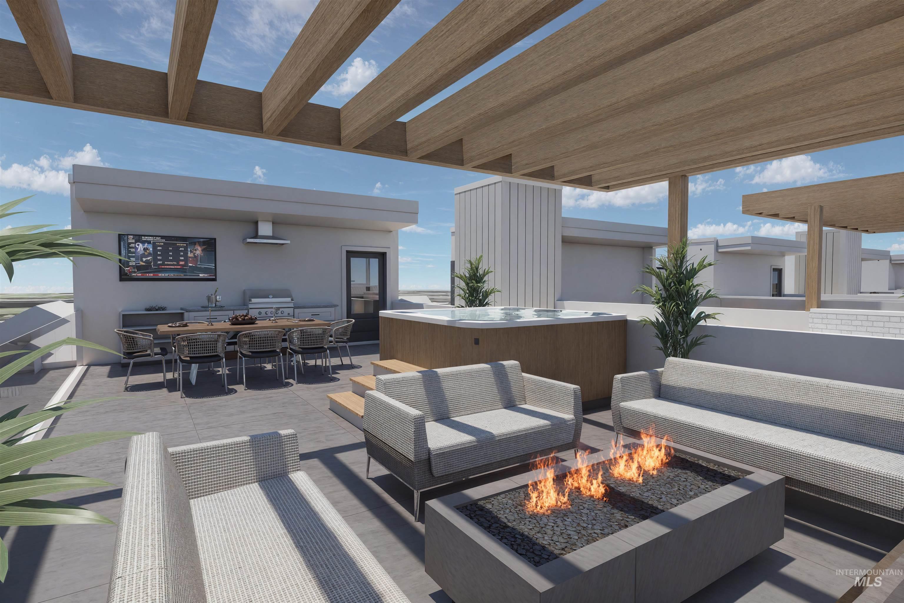 View of patio with a hot tub, outdoor dining space, a grill, and an outdoor living space with a fire pit