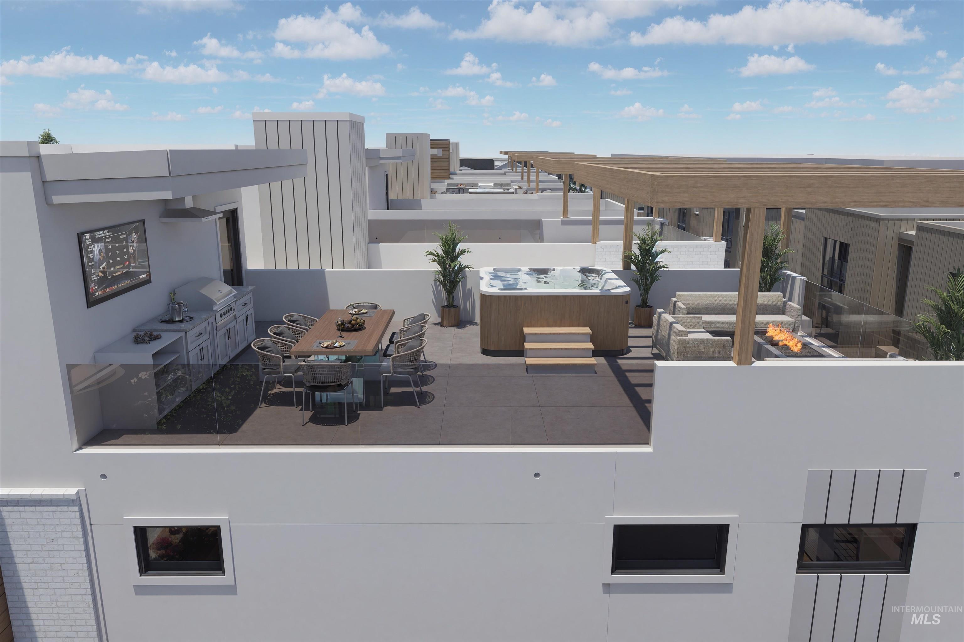 View of patio / terrace featuring exterior kitchen, an outdoor fire pit, and outdoor dining area