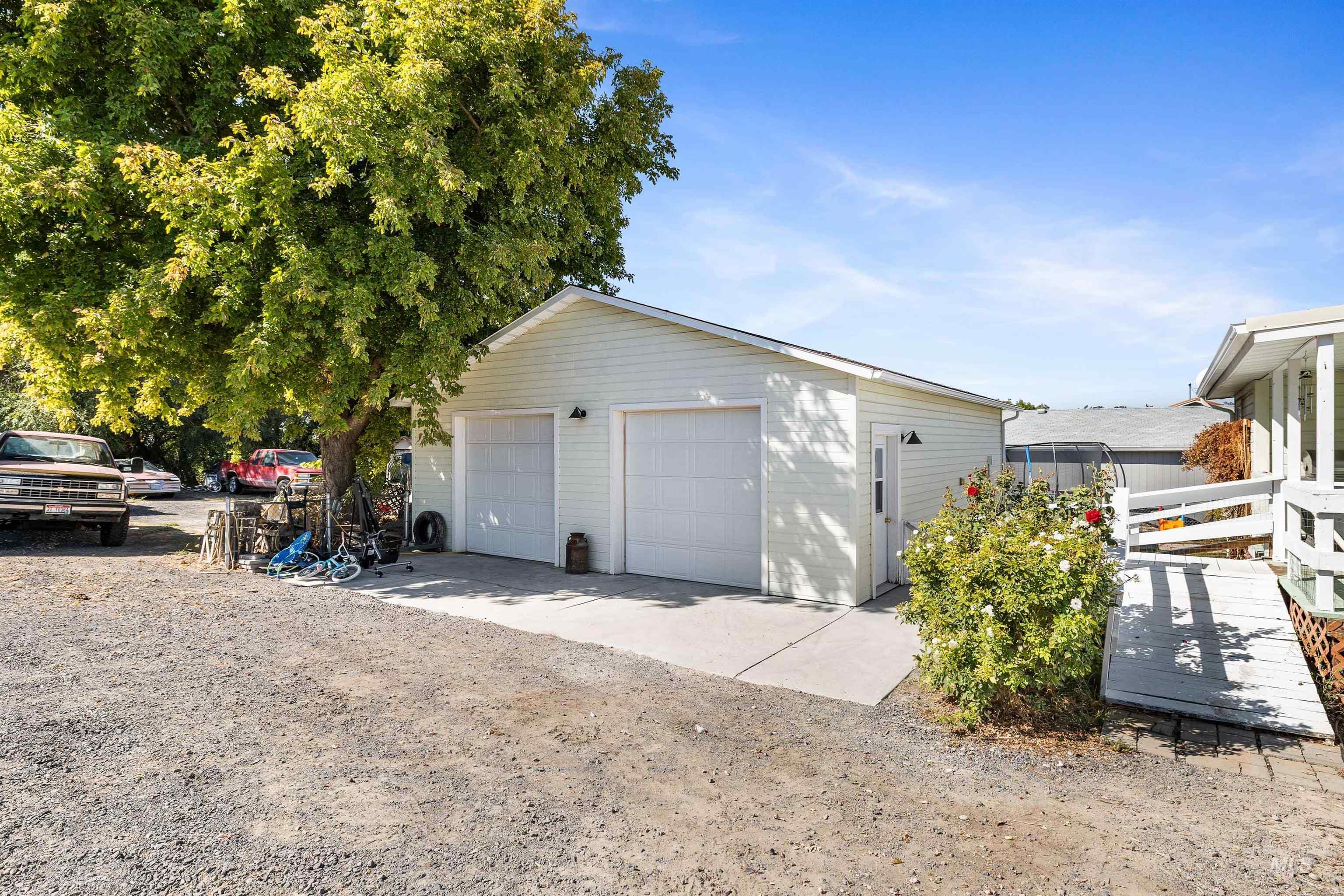 View of property exterior featuring an outdoor structure and a detached garage