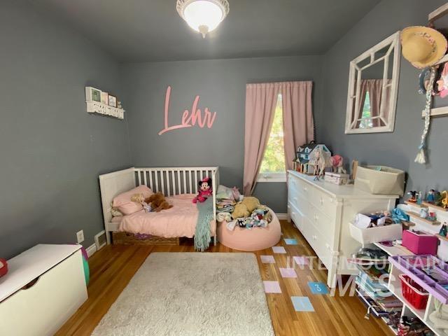 Bedroom featuring light wood-type flooring and baseboards