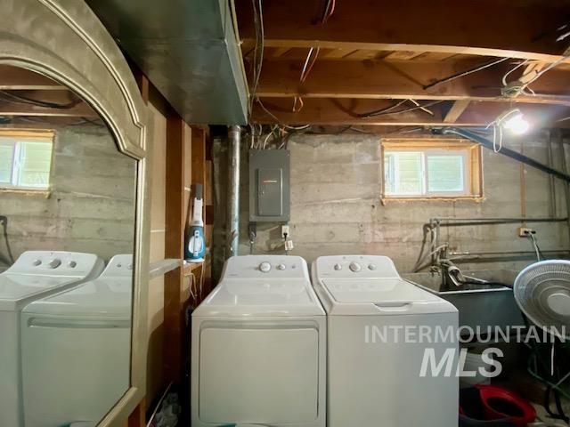 Laundry room with washing machine and clothes dryer and electric panel