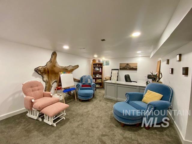 Living area with carpet flooring and recessed lighting