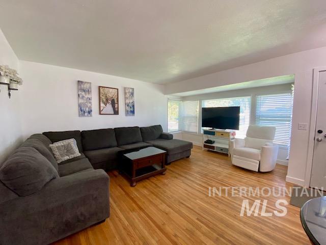 Living room with light wood-style flooring