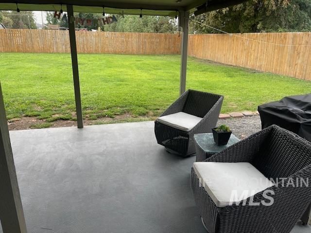 Fenced backyard with a patio