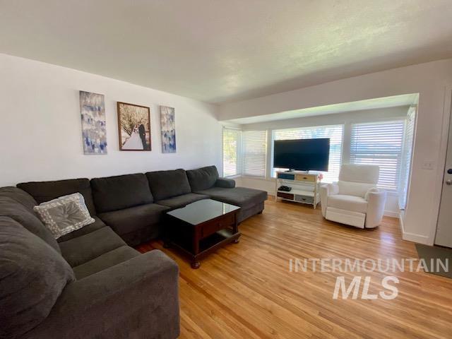 Living room with plenty of natural light and light wood finished floors