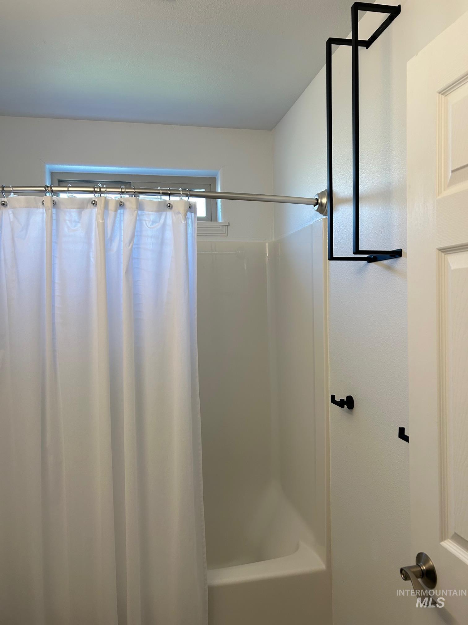 Full bathroom featuring shower / bath combo with shower curtain