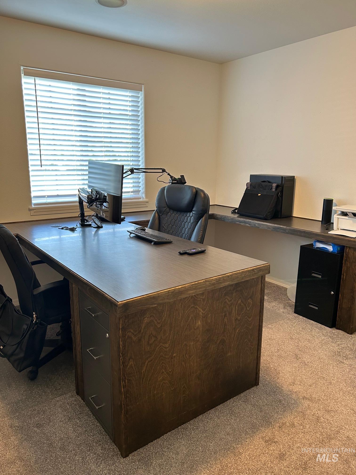 Home office with light colored carpet