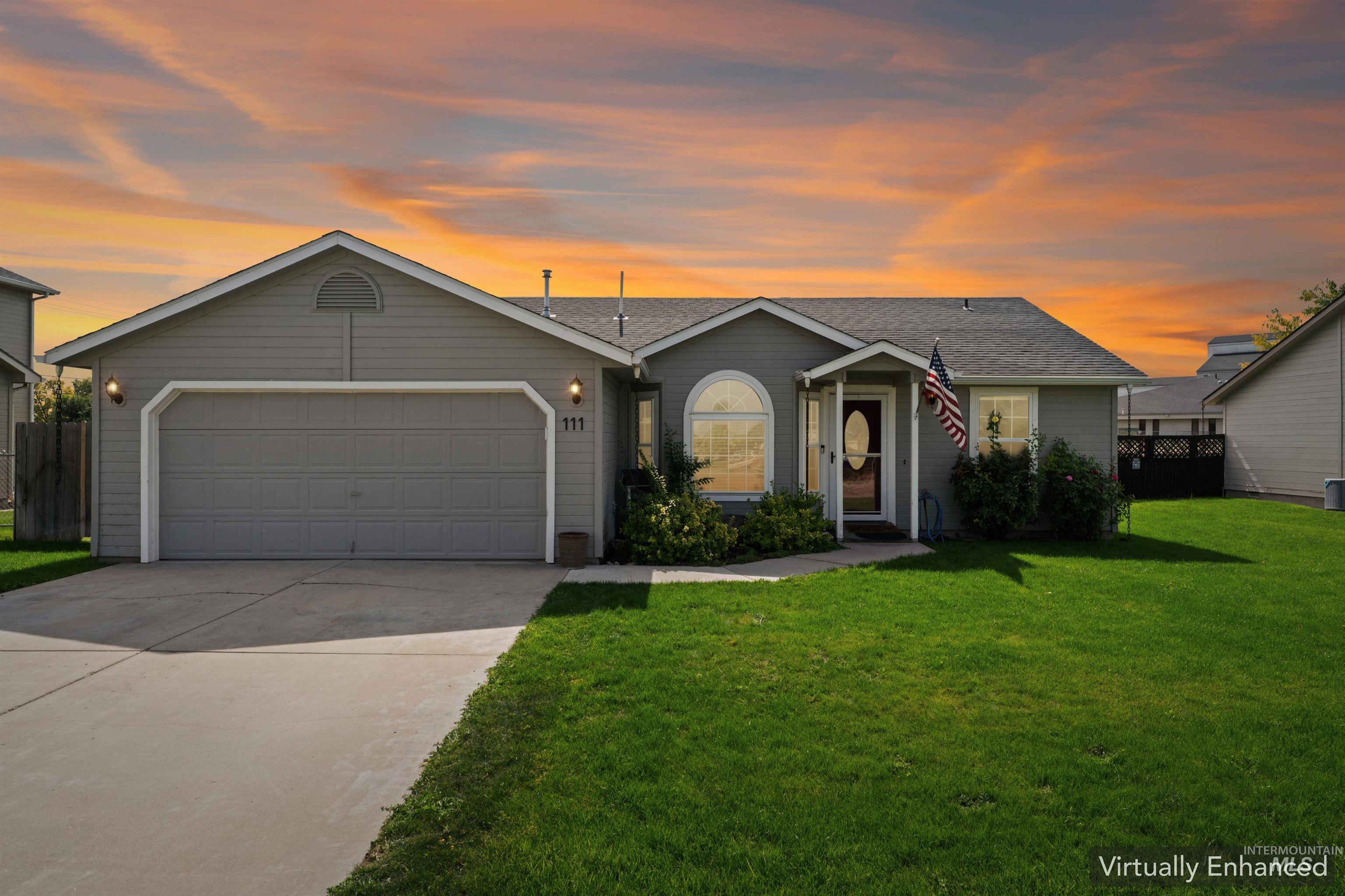 View of front of property featuring concrete driveway, a garage, and roof with shingles