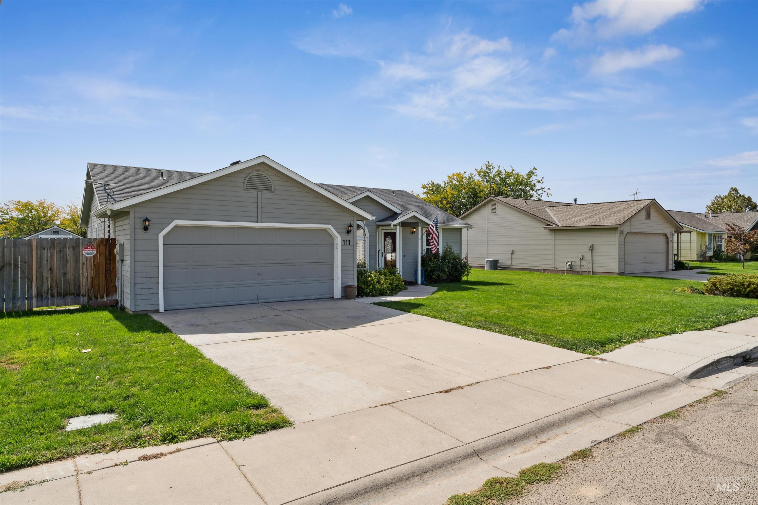 Single story home featuring concrete driveway and an attached garage