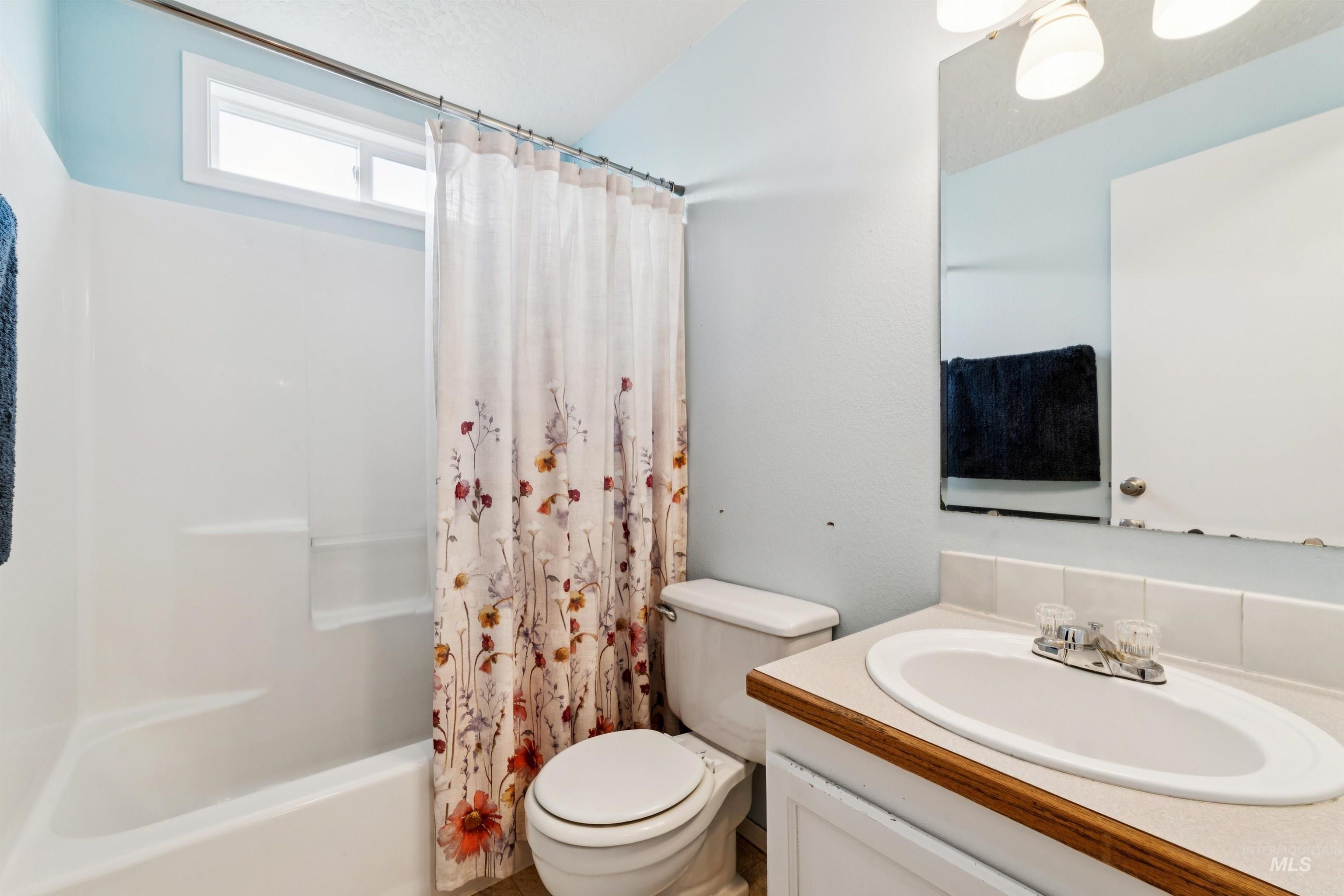 Full bath featuring vanity and shower / tub combo