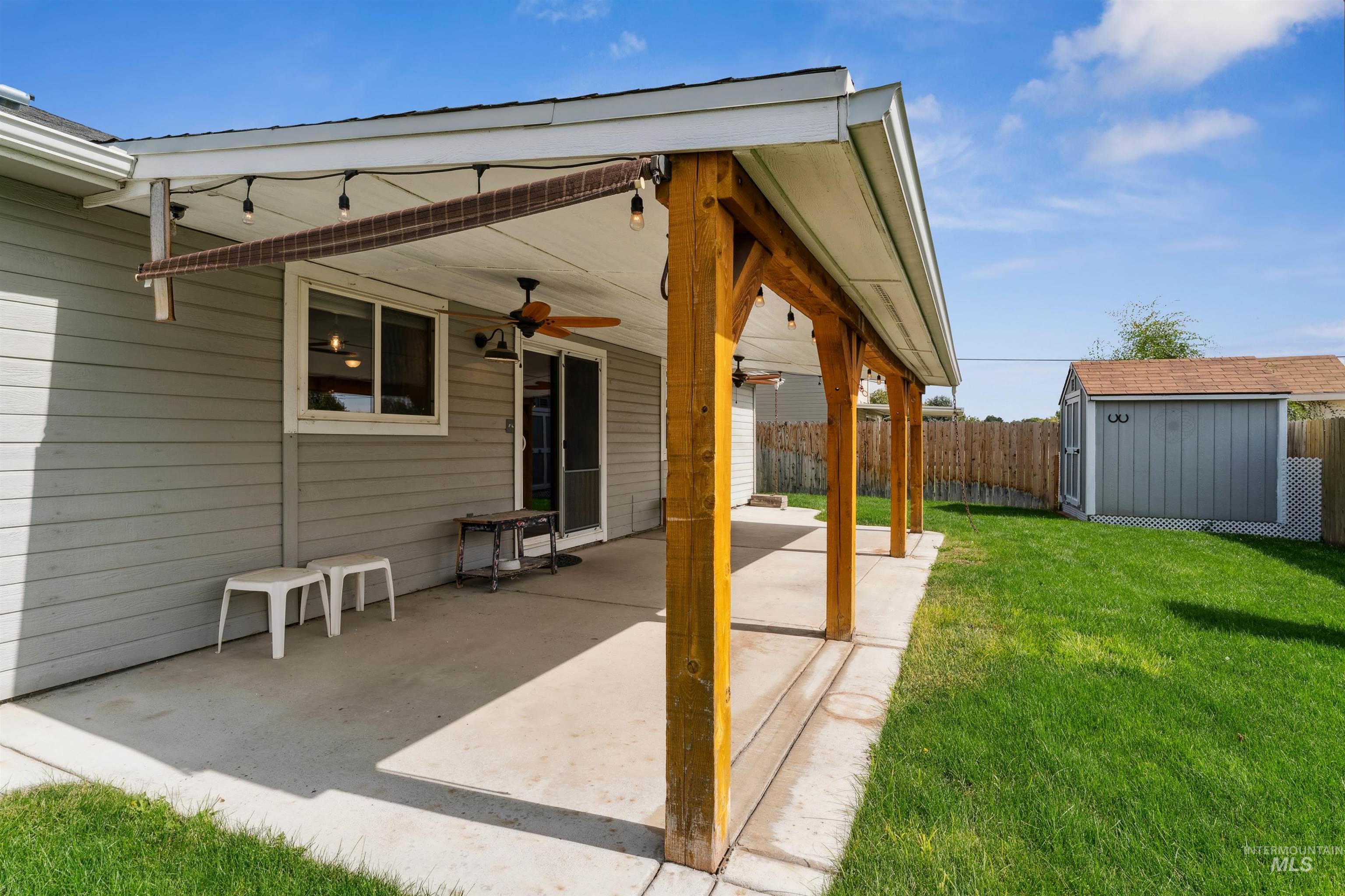 View of patio / terrace featuring a shed and ceiling fan
