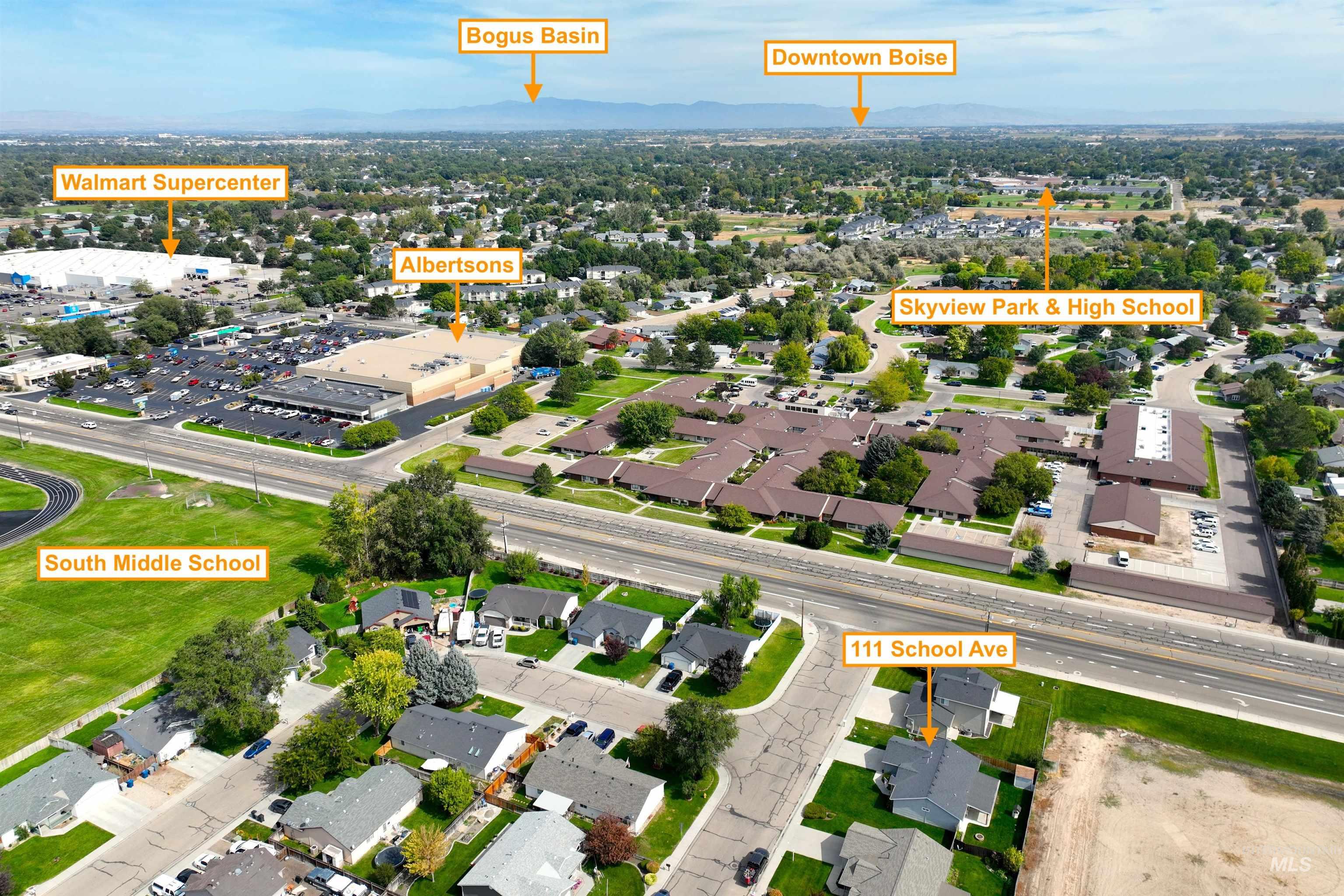 Aerial overview of property's location featuring a mountainous background and nearby suburban area